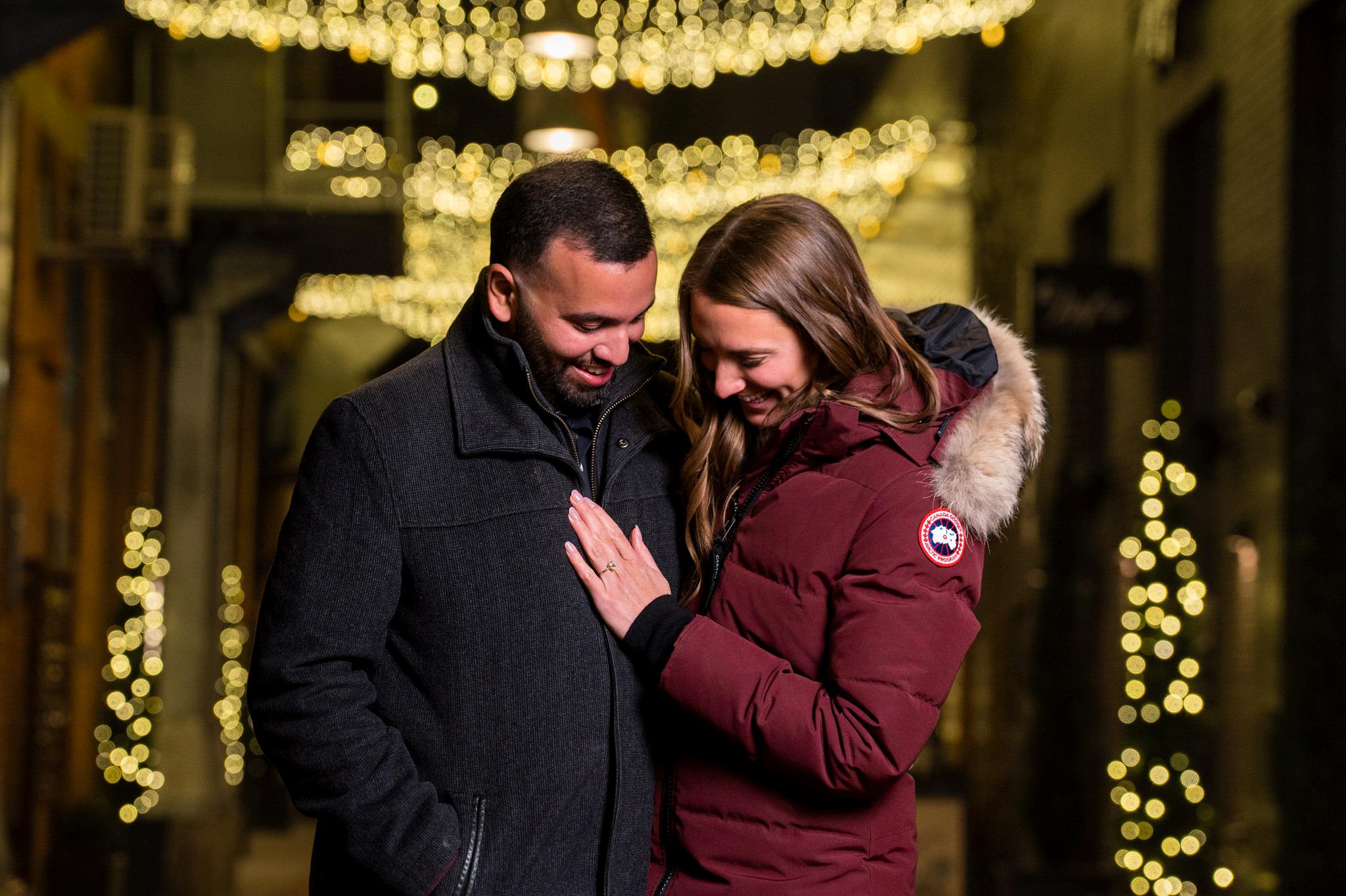 A couple admires an engagement ring after their Parker's Alley proposal.  