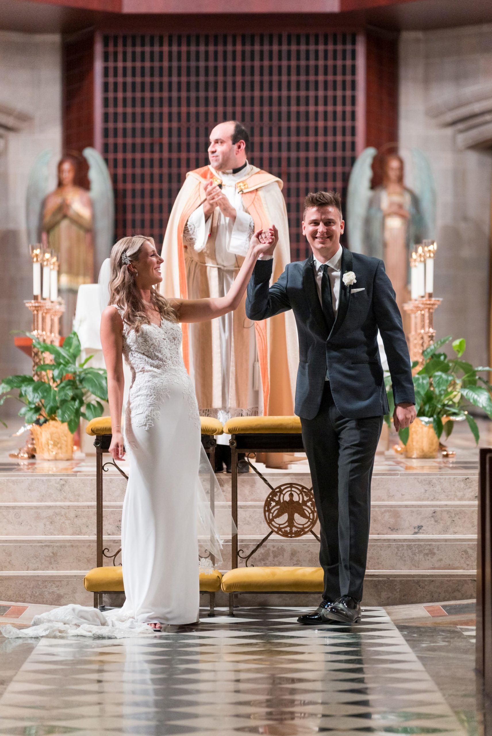 A couple celebrate as they are announced husband and wife at the Cathedral of the Most Blessed Sacrament church in Detroit, MI.