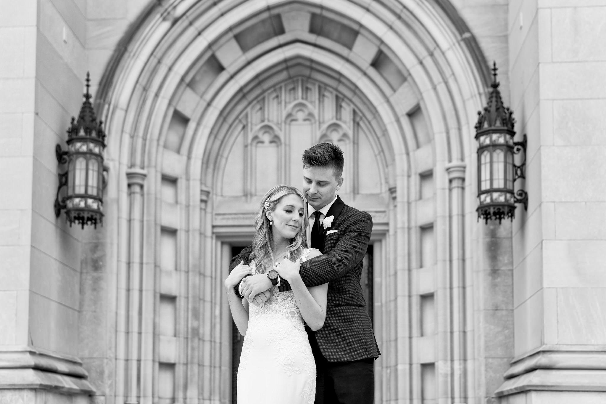 A groom holds his bride outside of the Cathedral of the Most Blessed Sacrament in Detroit, MI.
