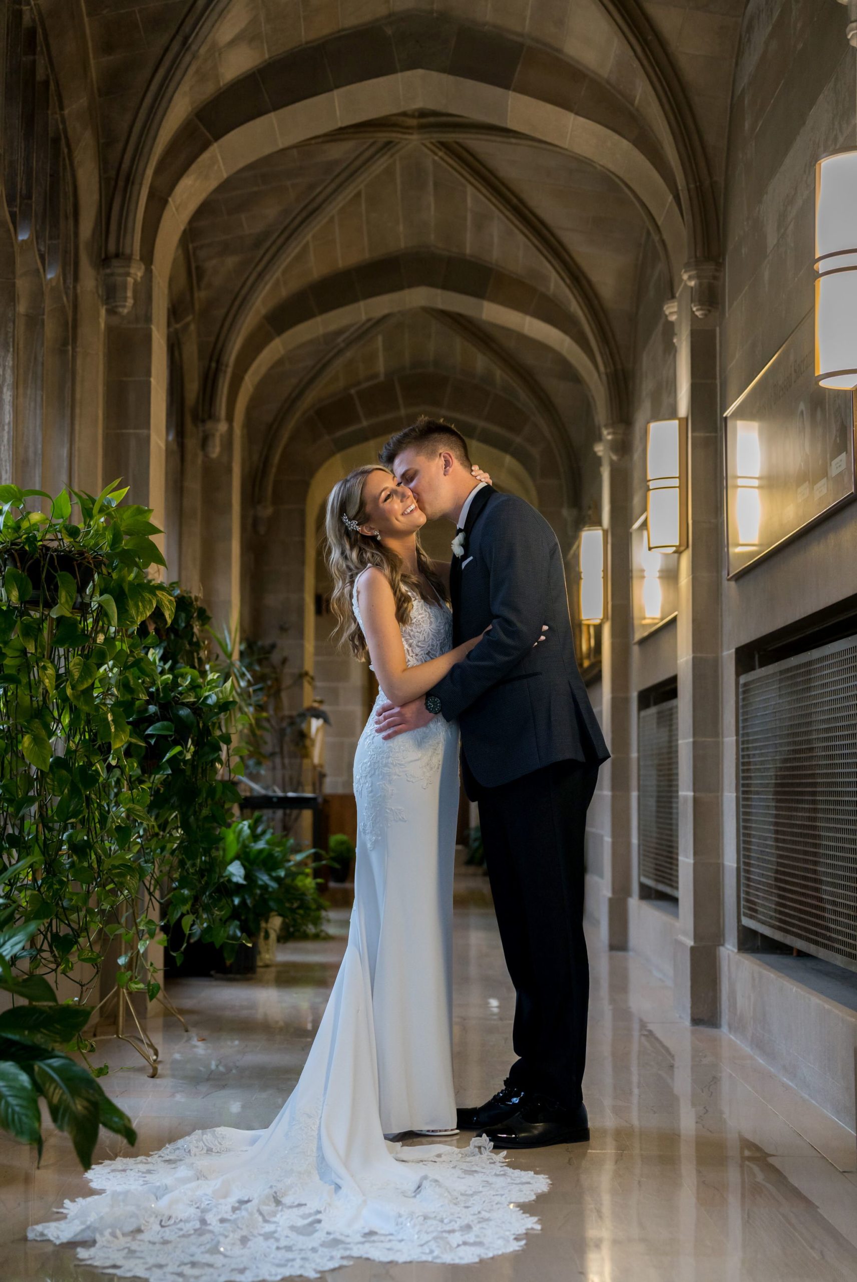 A bride receives a kiss from her husband at their Cathedral of the Most Blessed Sacrament ceremony.  