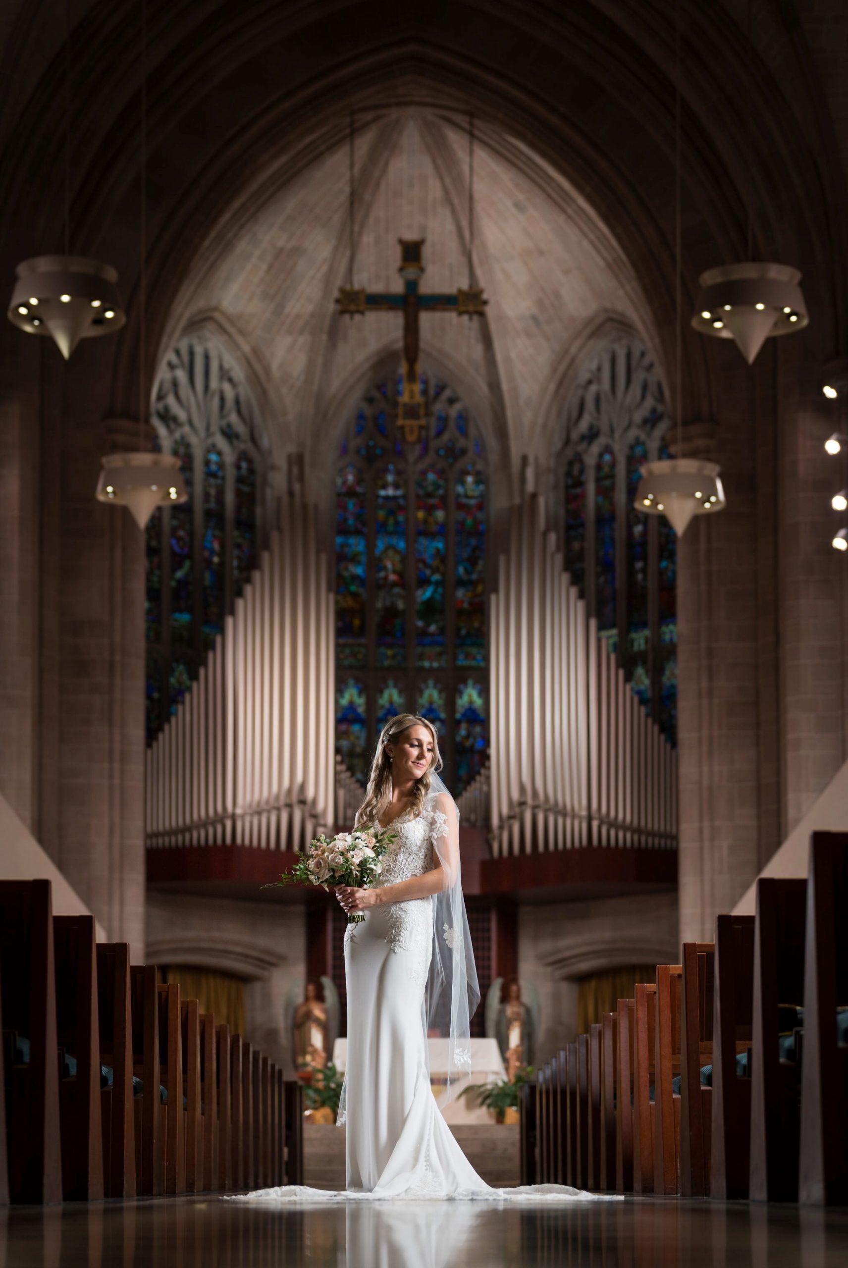 A bride poses in the aisle of the Cathedral of the Most Blessed Sacrament on her wedding day.  