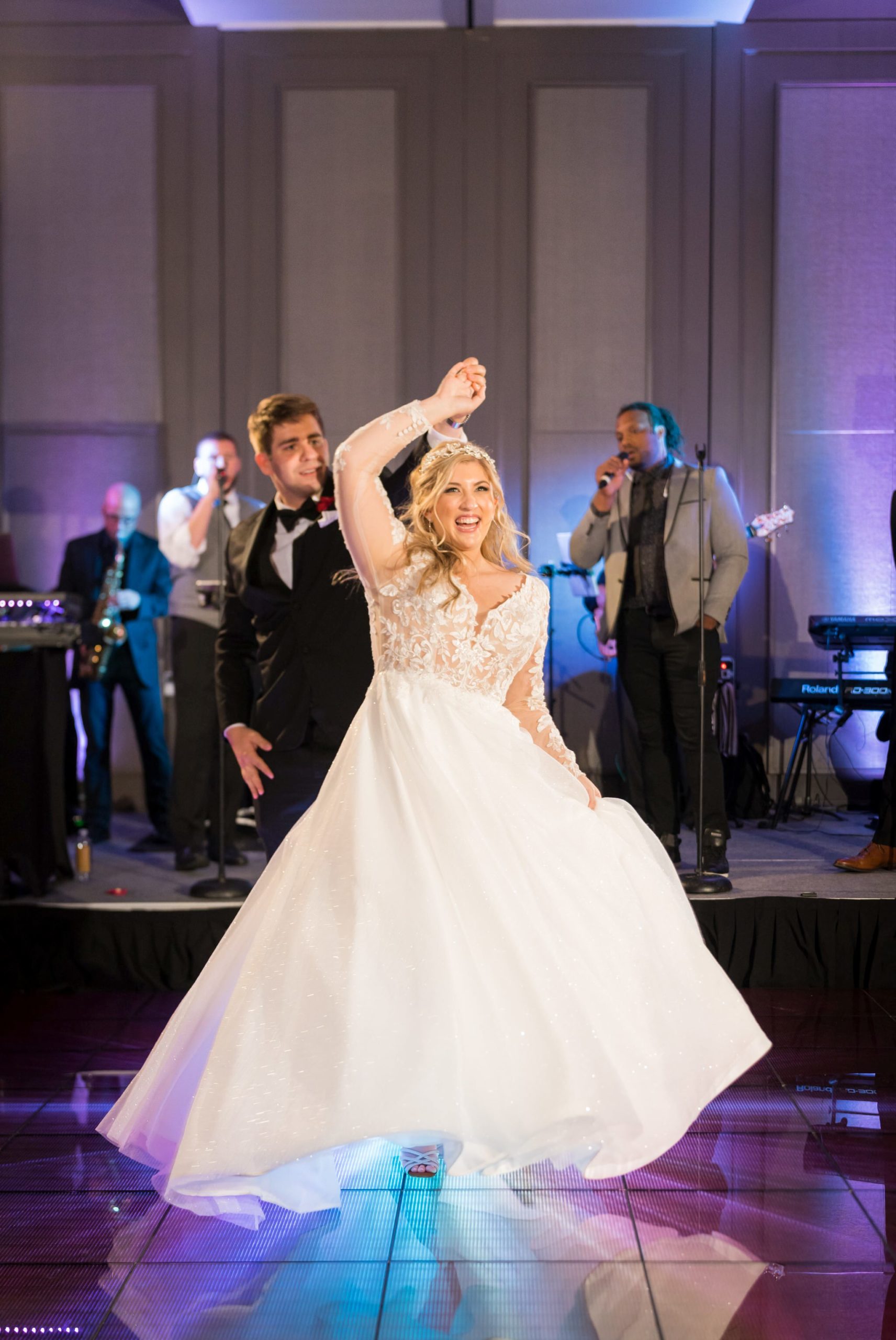 A bride twirls on the dance floor at her Daxton Hotel wedding.  