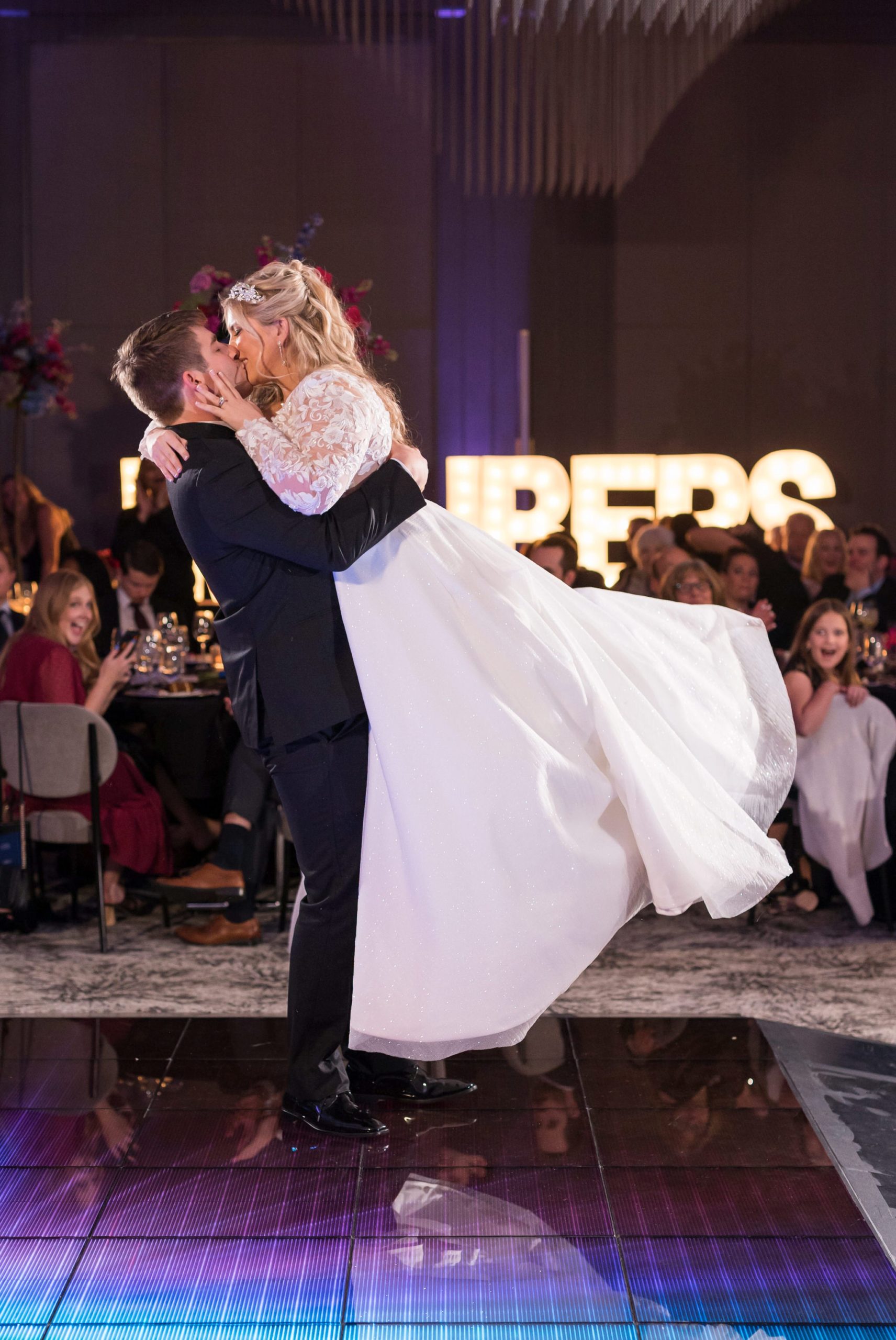 A bride and groom finish their first dance with a lift and kiss at their Daxton Hotel wedding. 