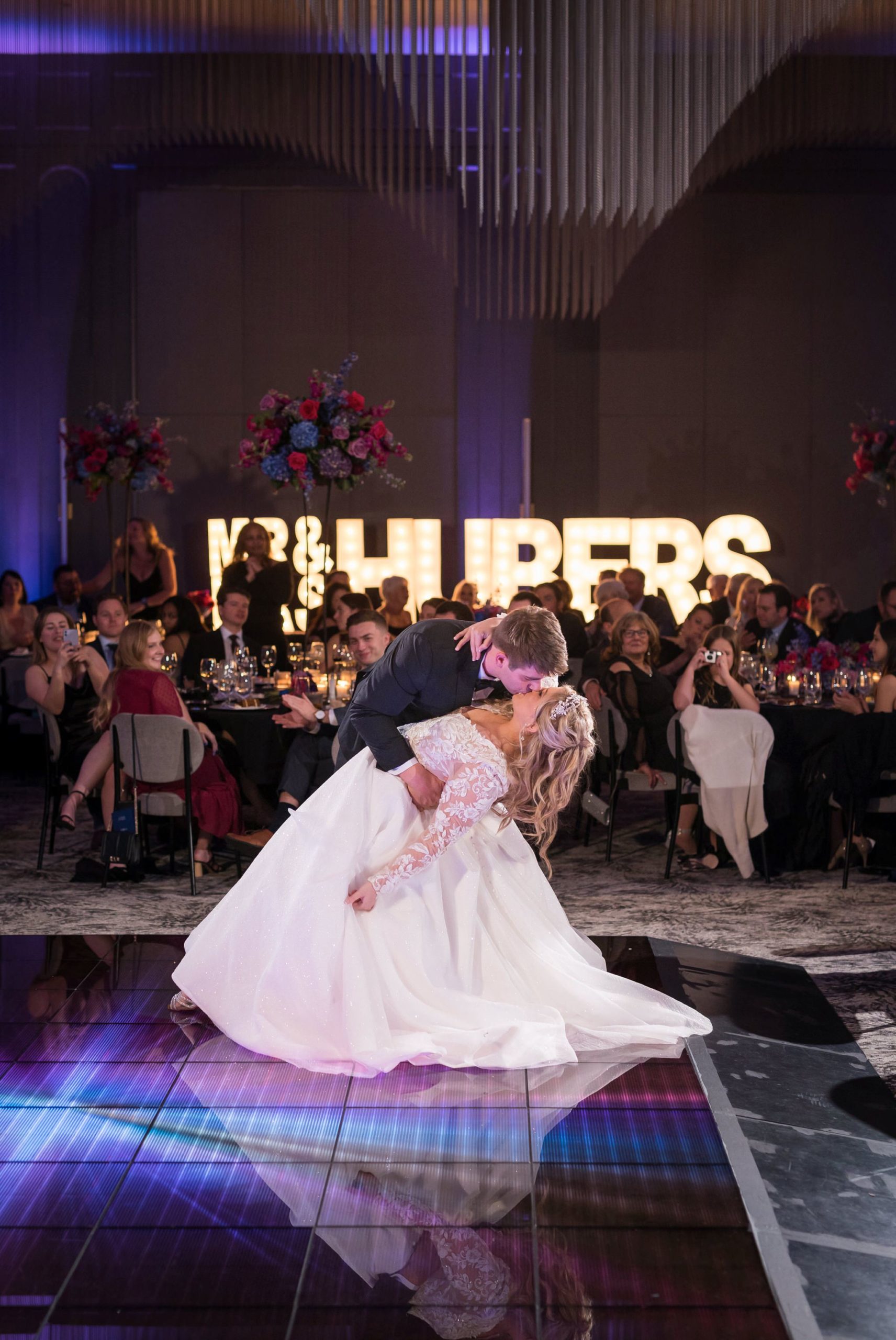 A bride and groom finish their first dance with a dip and kiss at their Daxton Hotel wedding. 