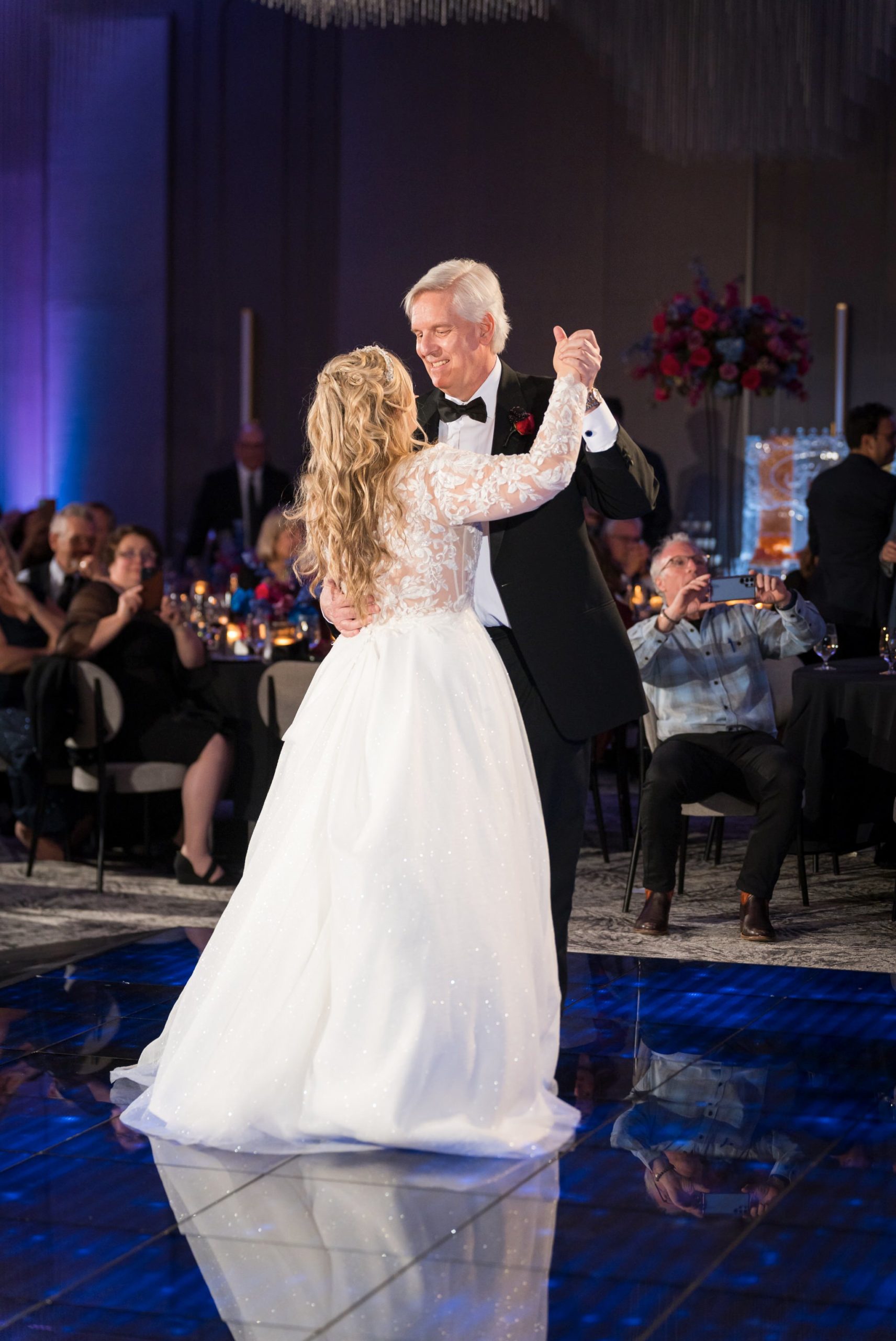 A bride dances with her father-in-law at a winter wedding at the Daxton Hotel. 