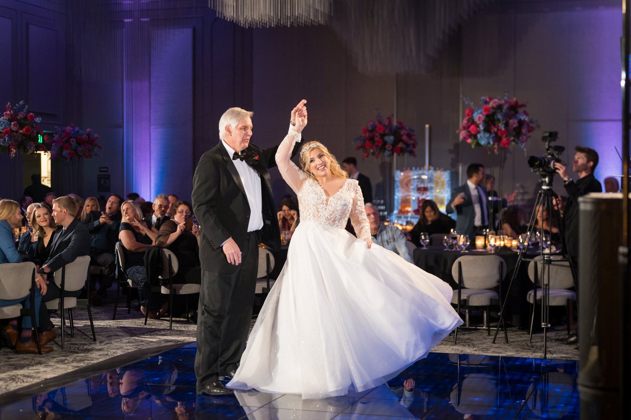 A dad and his daughter elegantly twirl on the dance floor of her Daxton Hotel wedding.  
