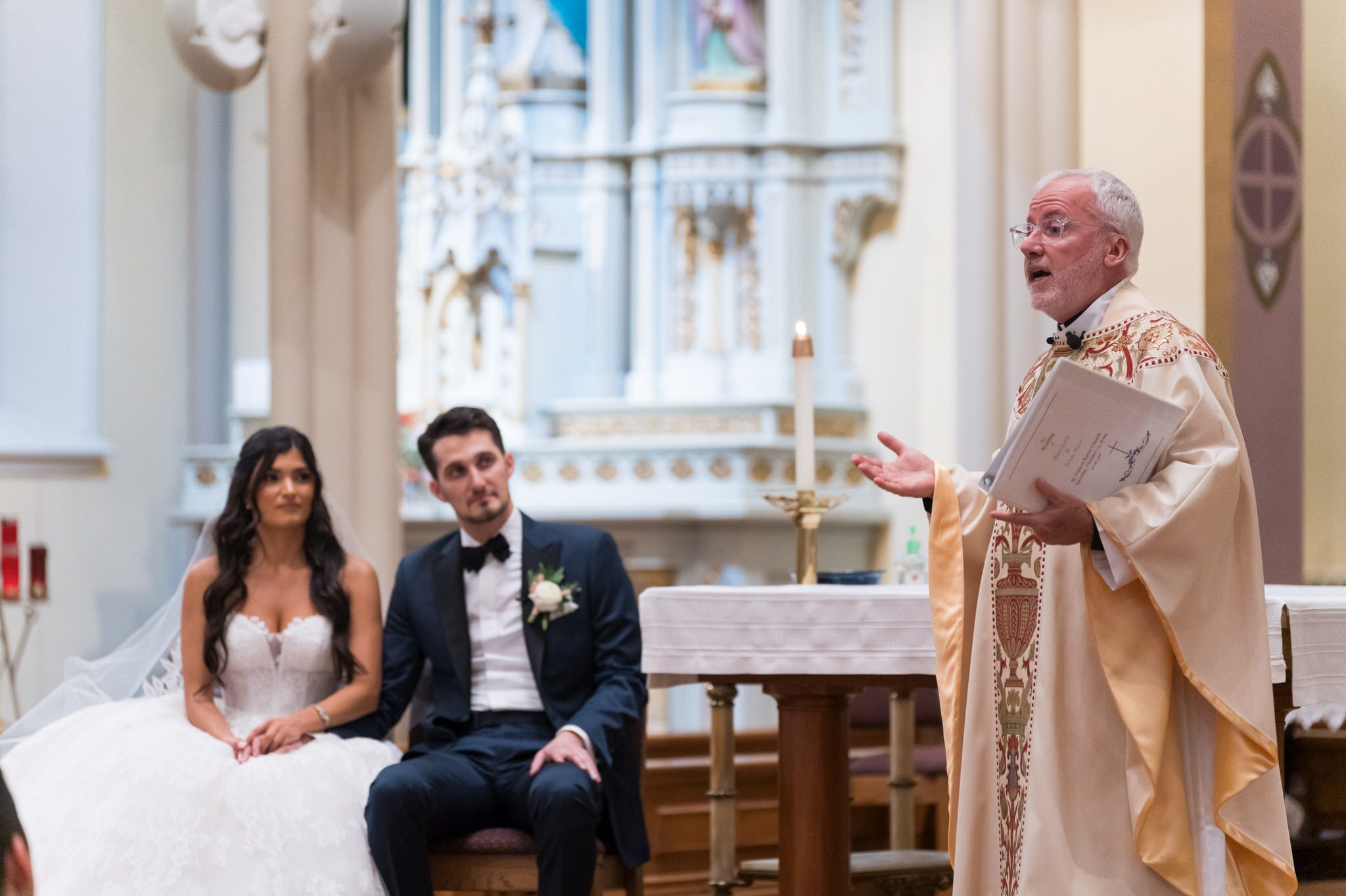 A priest delivers a wedding day homily at St. Francis Xavier church in Petoskey, MI. 