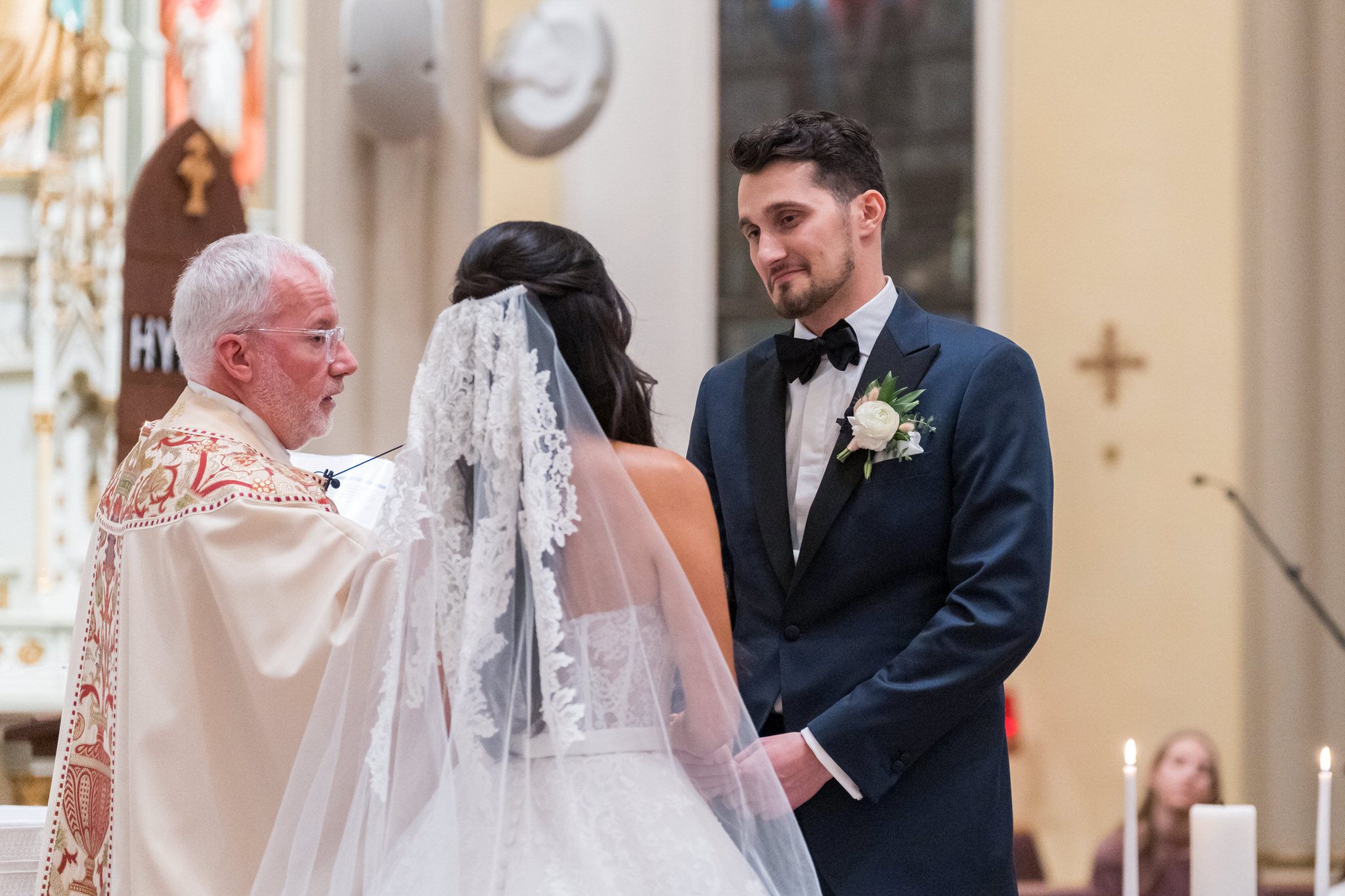 A couple exchange vows on their wedding day at St. Francis Xavier church in Petoskey, MI. 