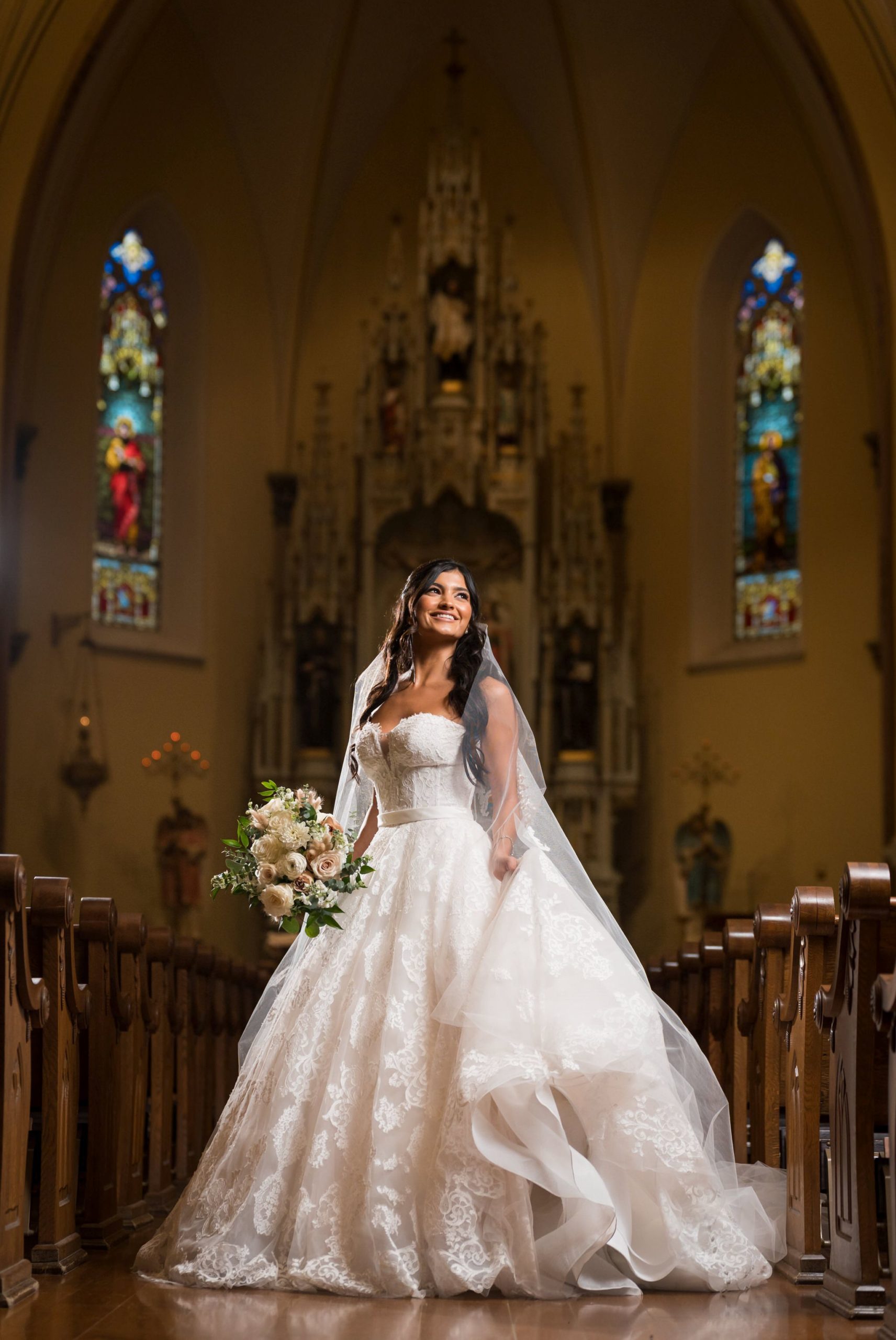 A bride looks angelic for a portrait at St. Francis Xavier Church in downtown Petoskey.   