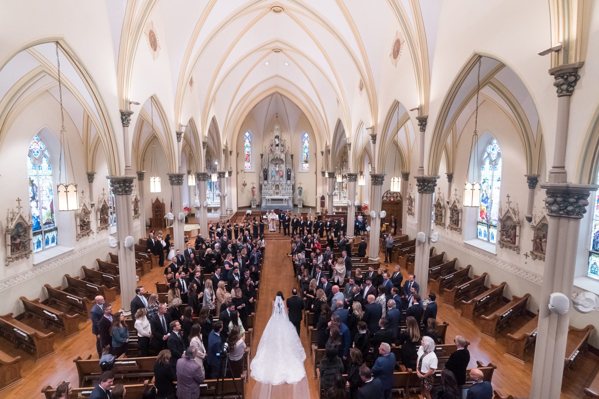 The bride walks down the aisle at St. Francis Xavier on her wedding day in downtown Petoskey.  
