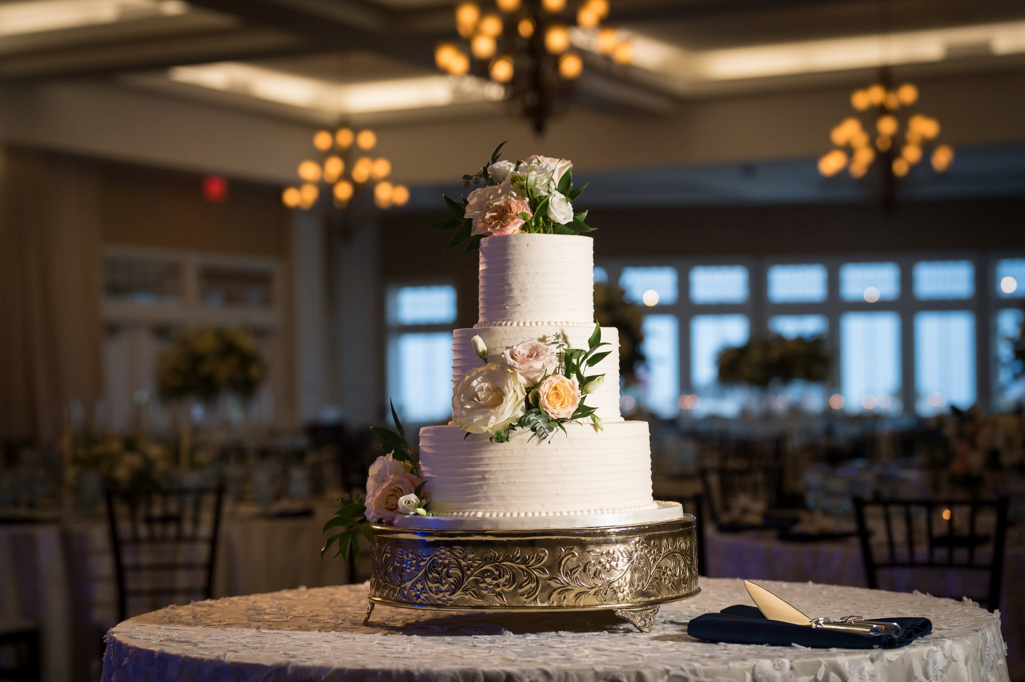 A wedding cake is displayed the ballroom of the Inn at Bay Harbor.  
