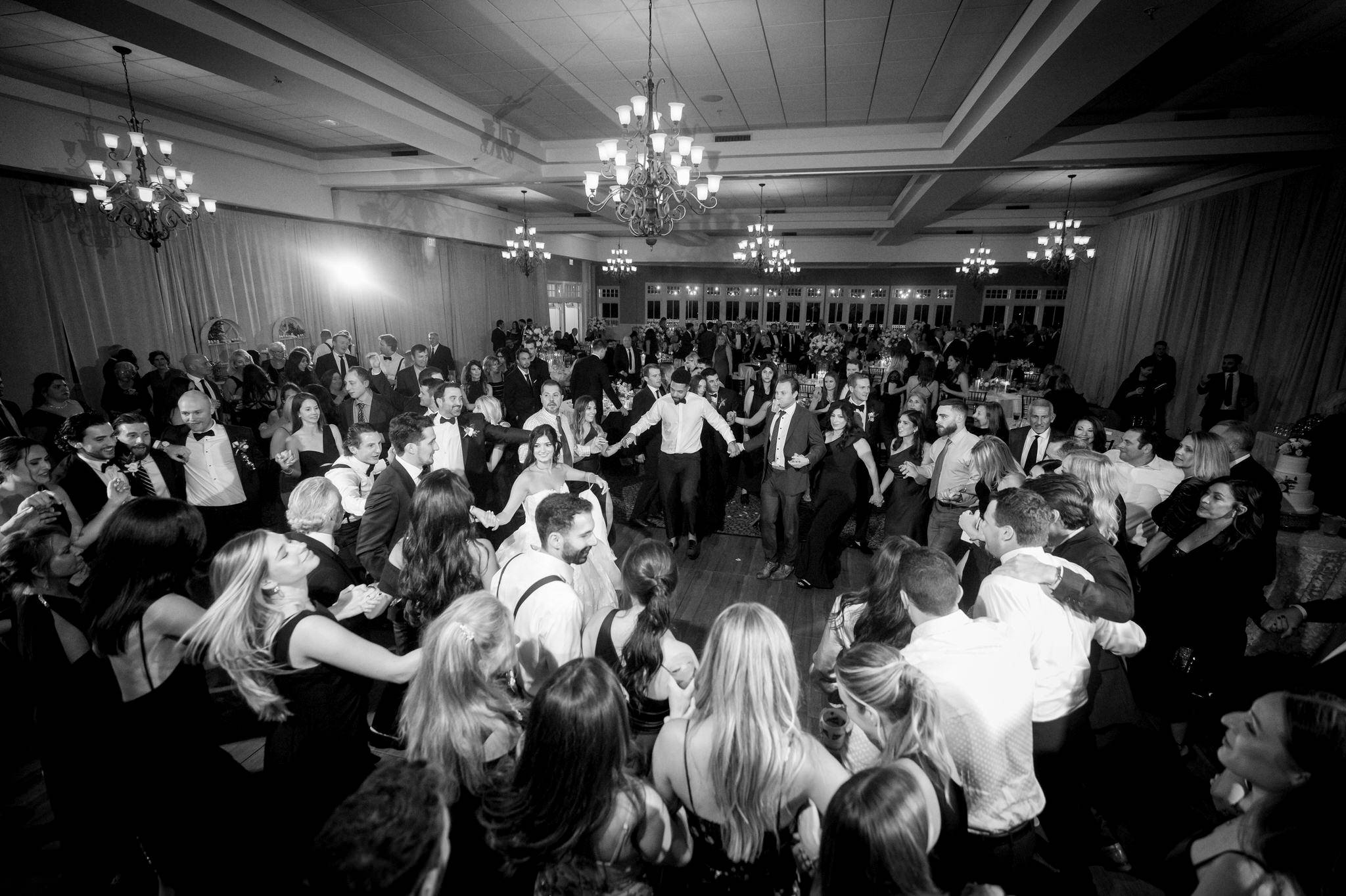 A circle dance is performed at a wedding at Bay Harbor.  