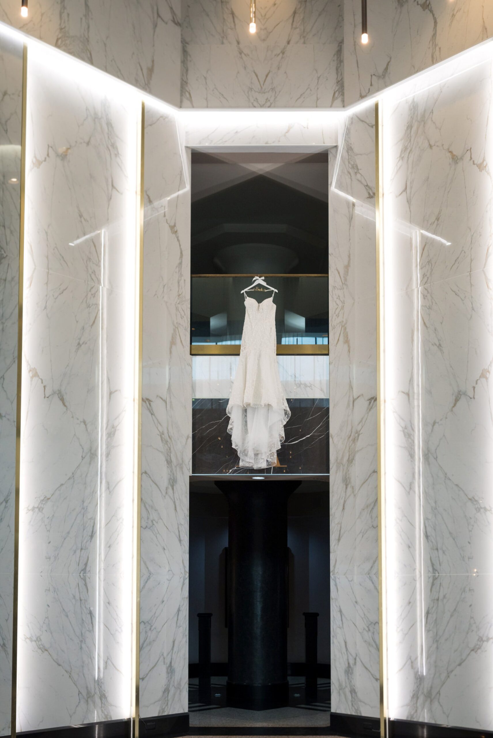 A wedding dress hangs in the lobby of the Atheneum Hotel in Detroit, MI.   