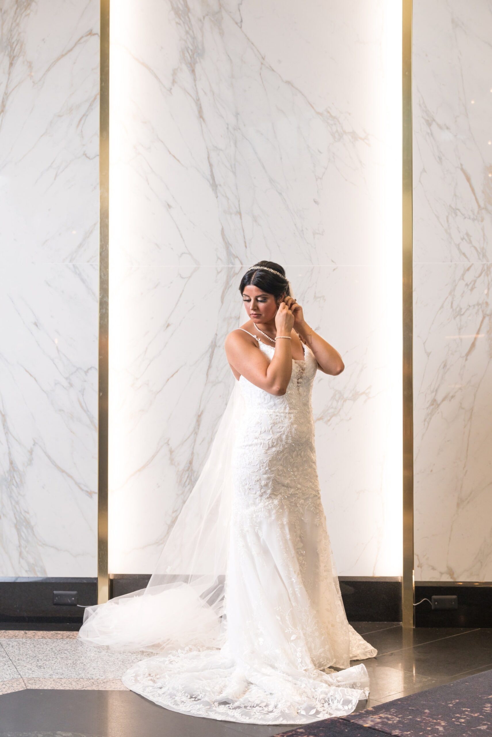 A bride gets ready for her wedding day in the lobby of the Atheneum Hotel. 