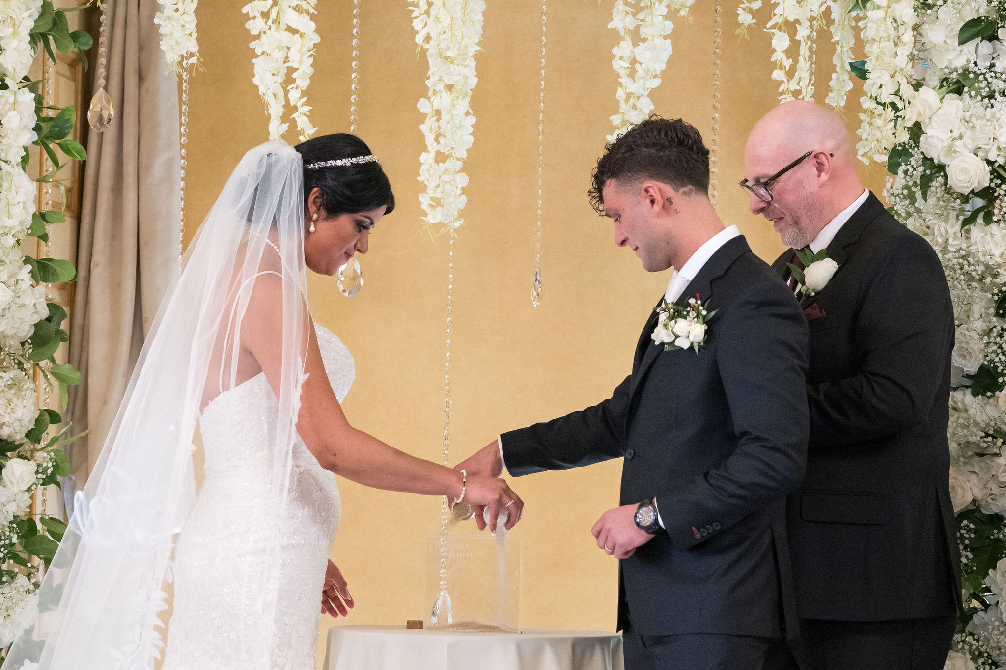 A bride and groom exchange vows at their Colony Club Detroit wedding ceremony. 