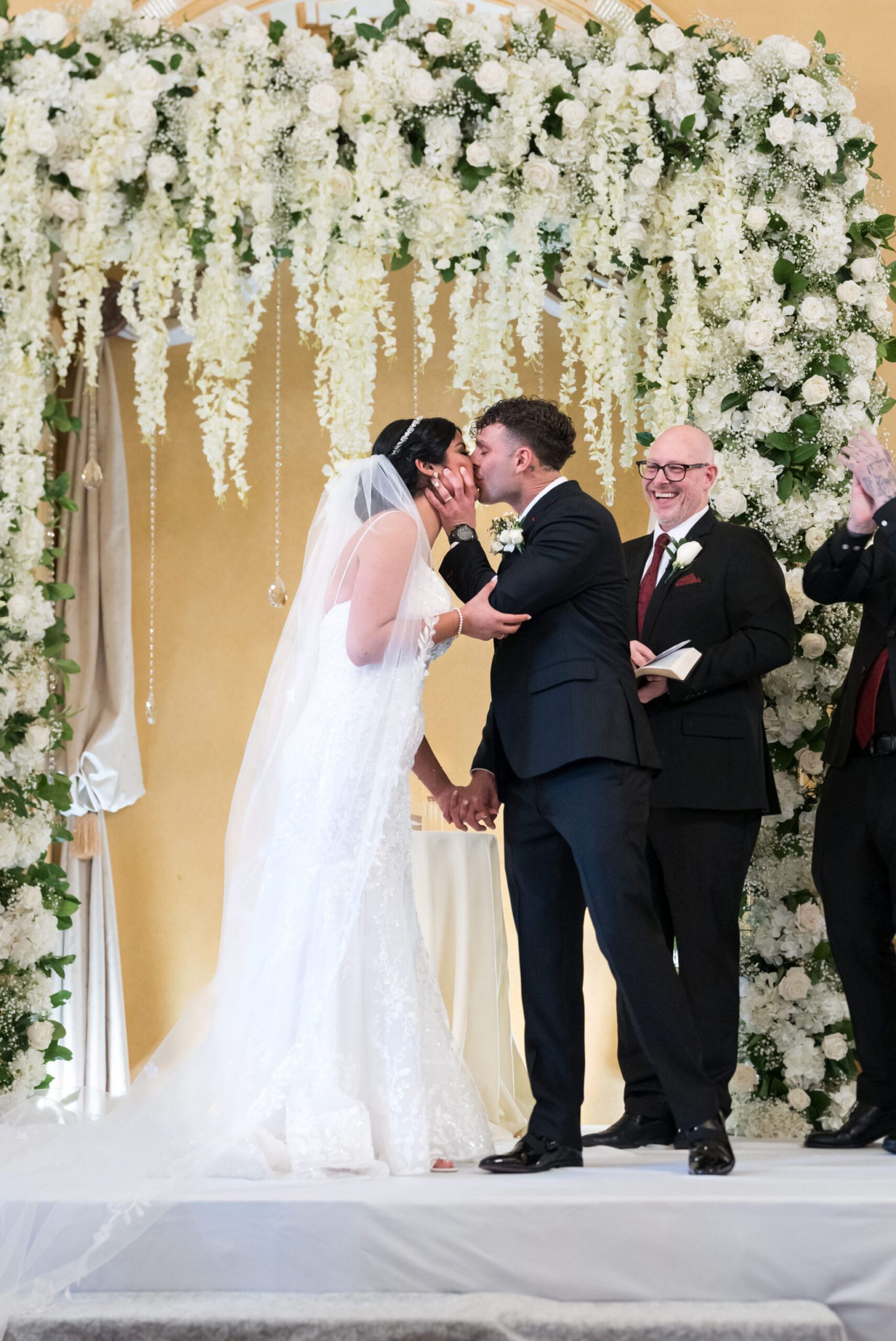 A bride and groom share their first kiss at their Colony Club Detroit wedding ceremony. 