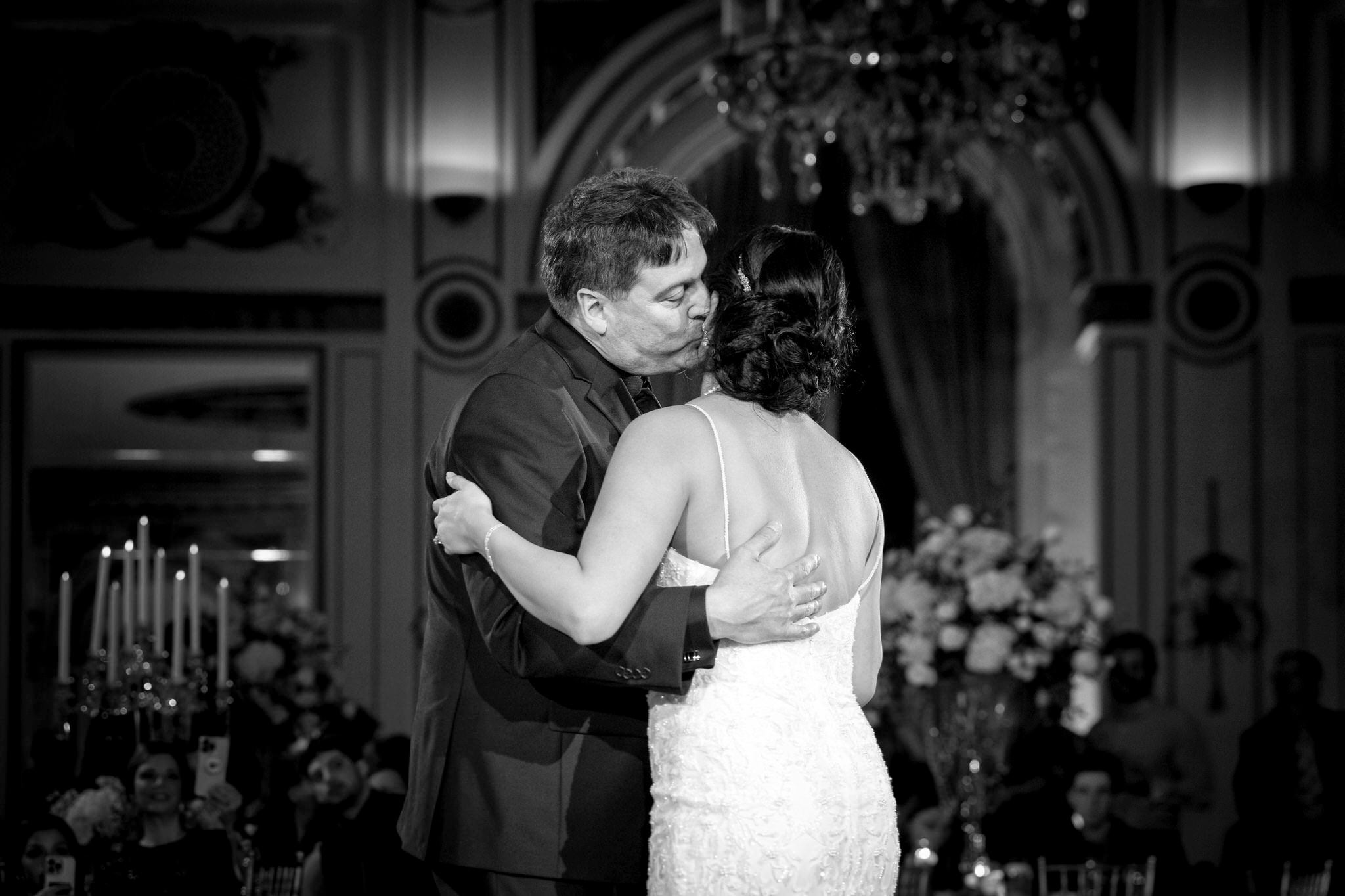 The father of the bride kisses his daughter during their first dance at her  Colony Club Detroit wedding.  
