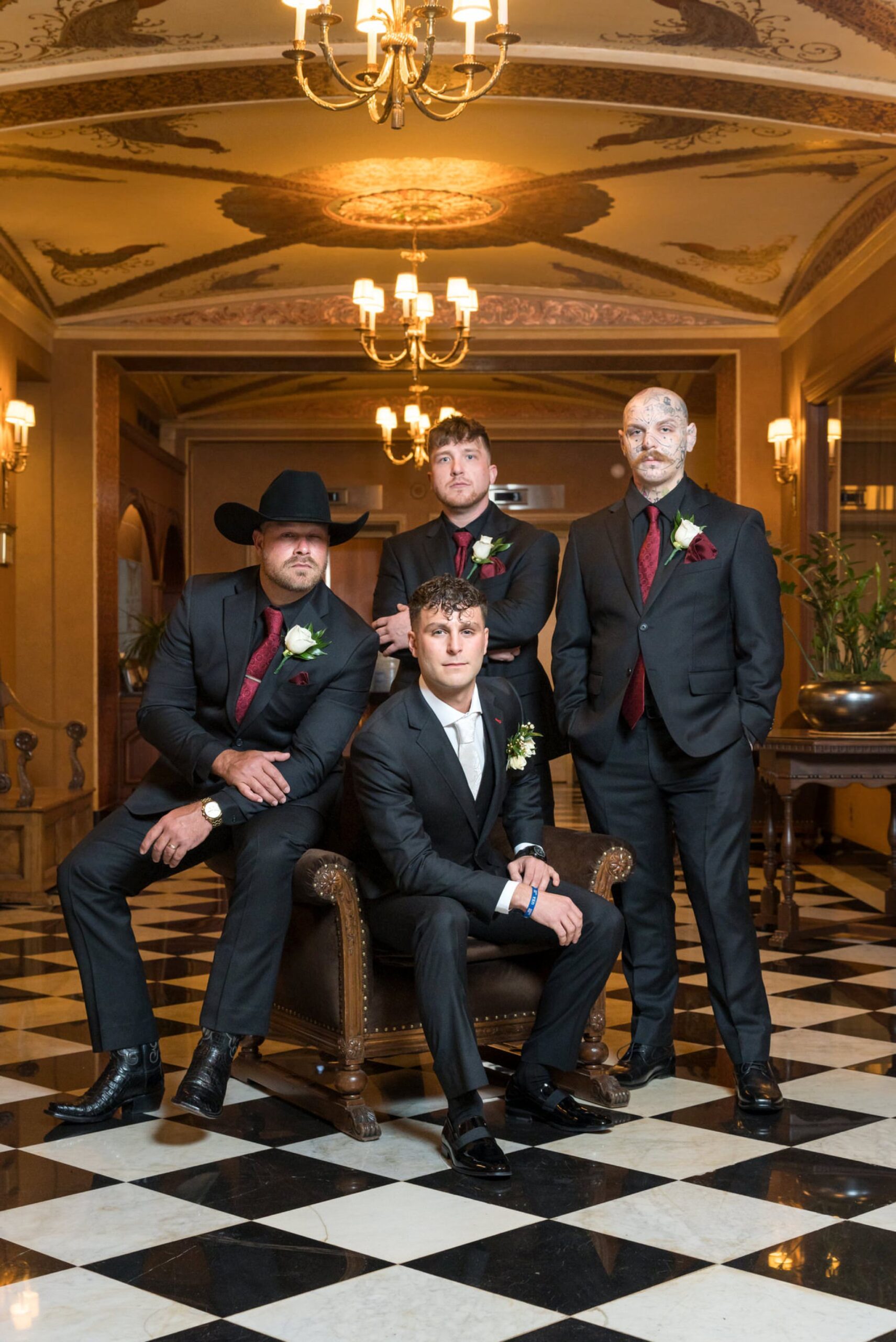 Groomsmen pose for a photo in the lobby of a Colony Club Detroit wedding.