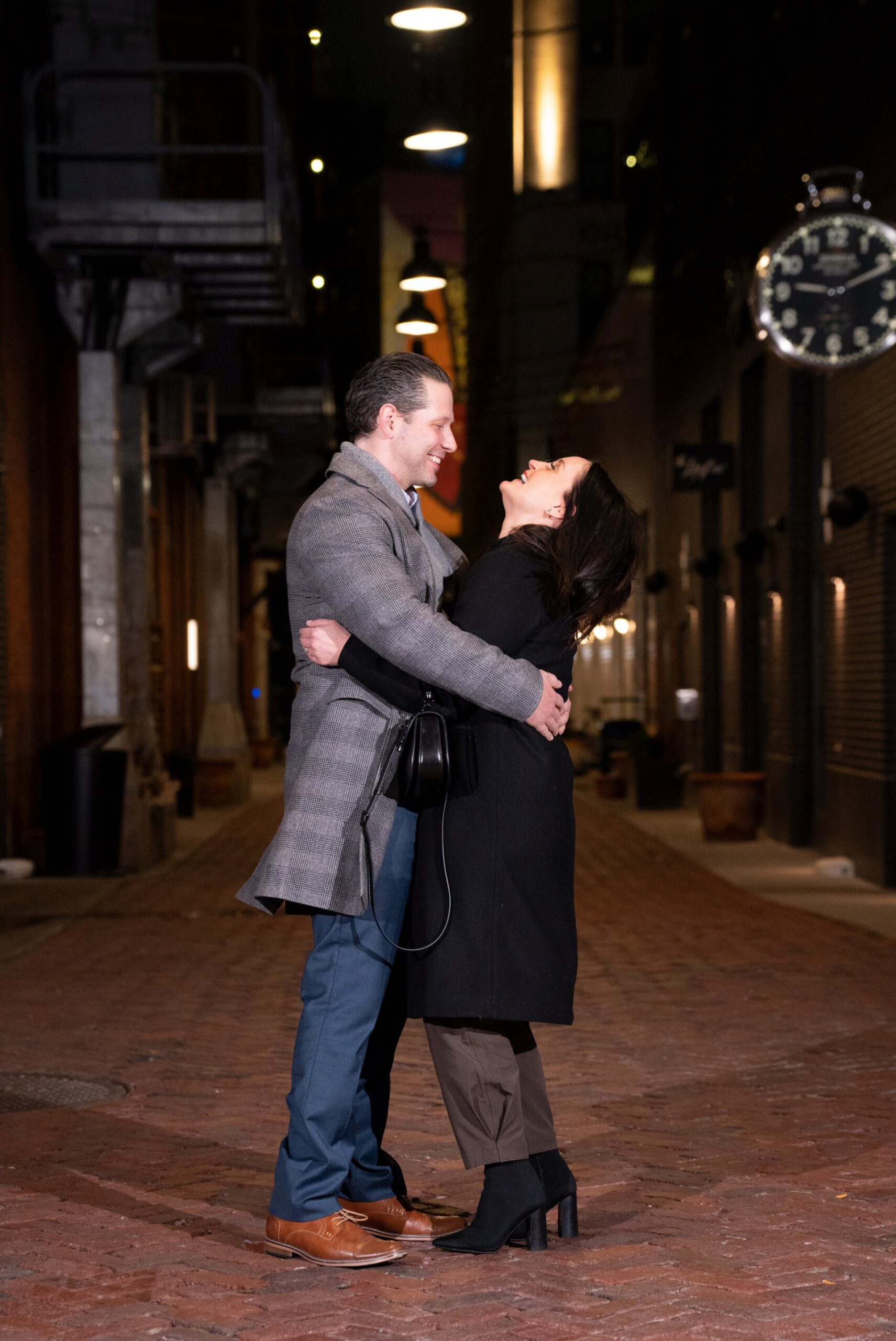 A couple hugs and laughs after saying "yes" to a marriage proposal in Parker's Alley, Detroit. 