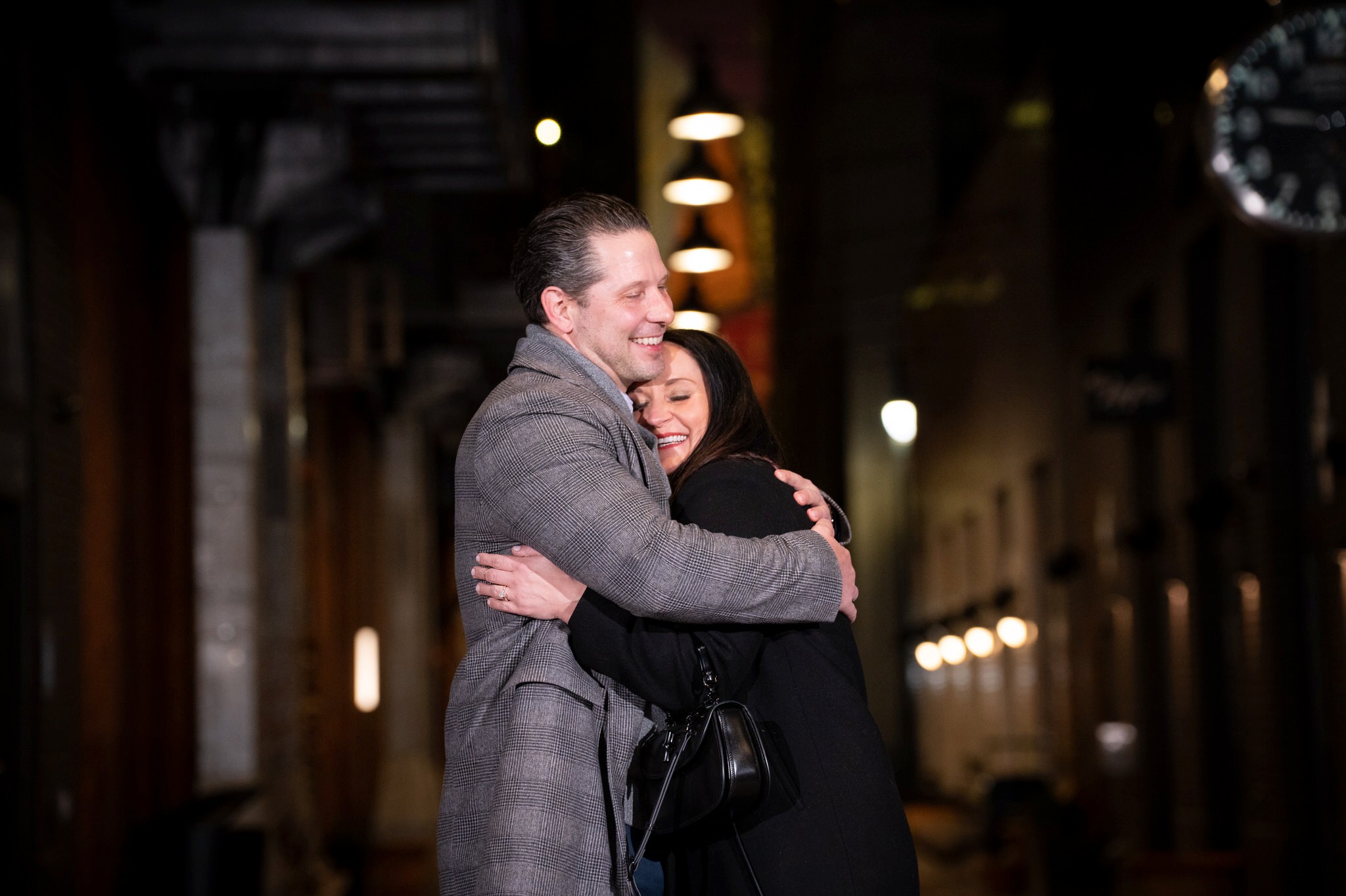 A couple hugs after saying "yes" to a marriage proposal in Parker's Alley, Detroit. 