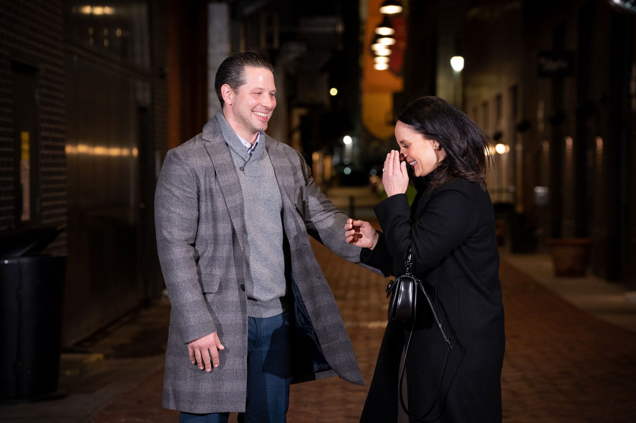A fiance reacts after becoming engaged during a proposal in Parker's Alley.