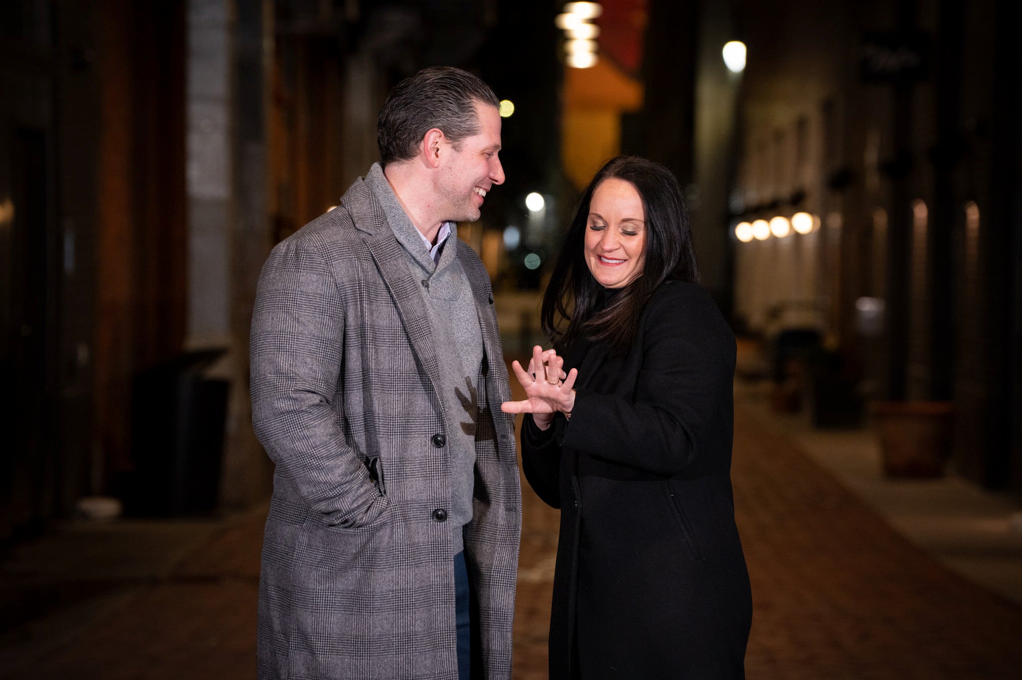 A fiance looks at her ring after a proposal in Parker's Alley. 