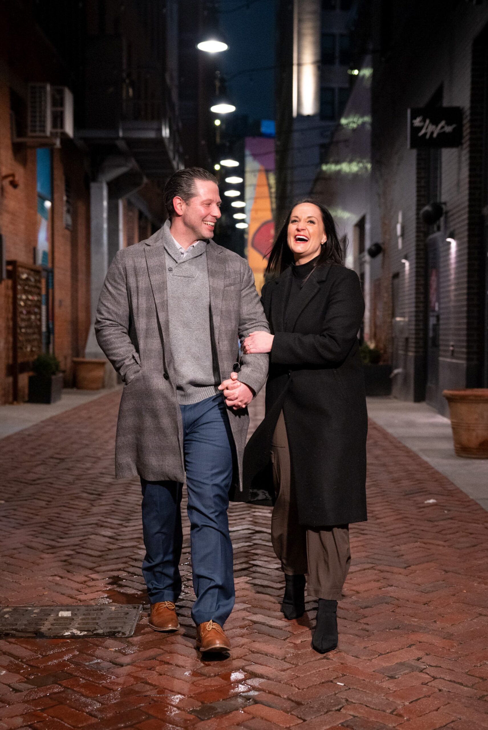A newly engaged couple walks away after a proposal in Parker's Alley.