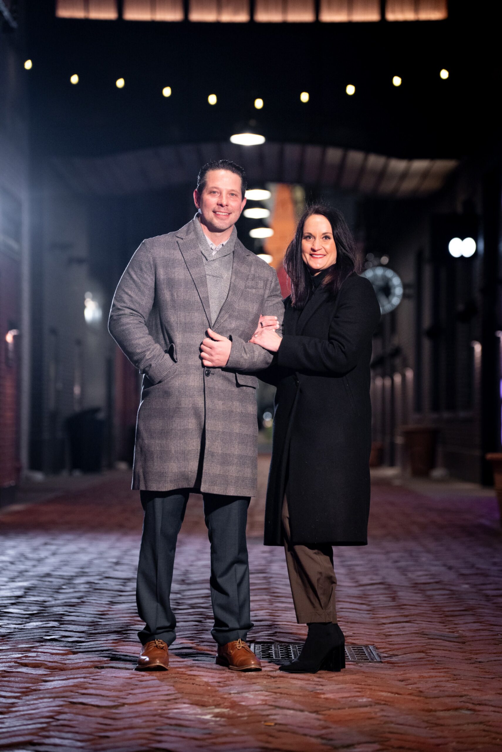 A newly engaged couple pose for a portrait in Parker's Alley. 