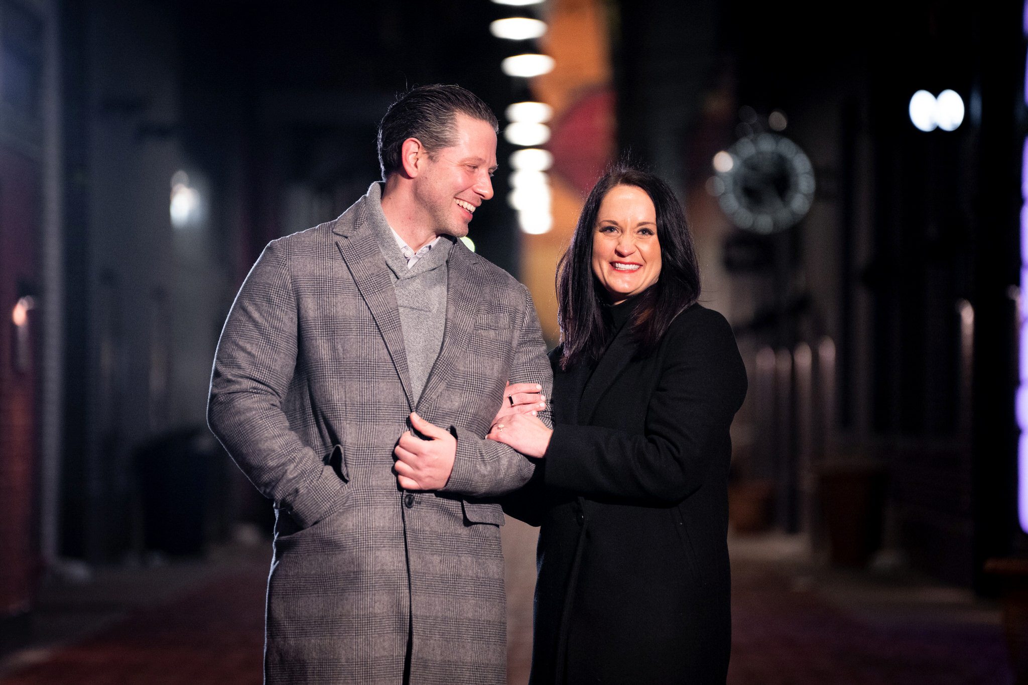 A newly engaged couple pose for a portrait in Parker's Alley. 