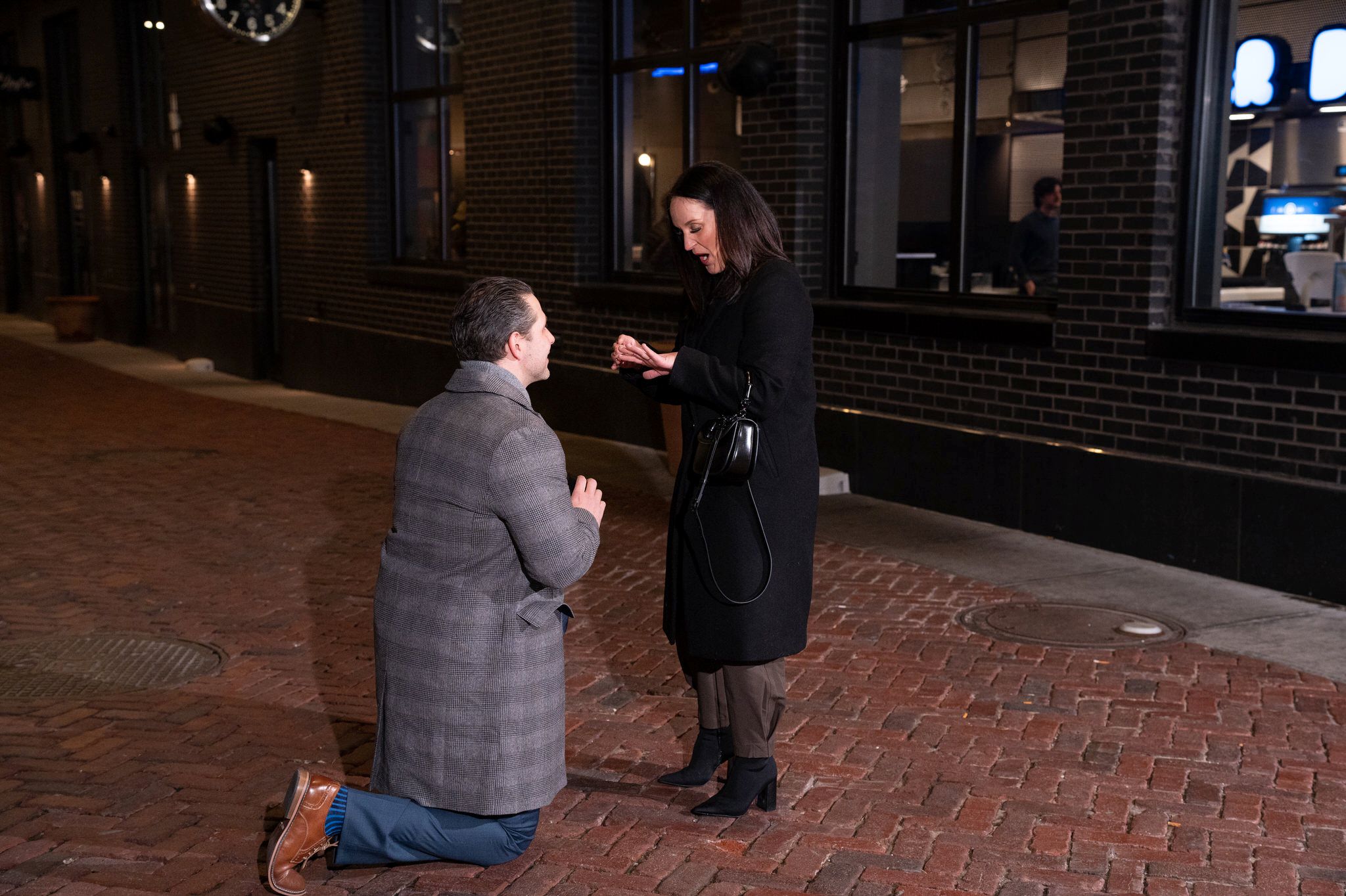 A fiance looks at her hand after saying "yes" to a marriage proposal in Parker's Alley in Detroit, MI. 