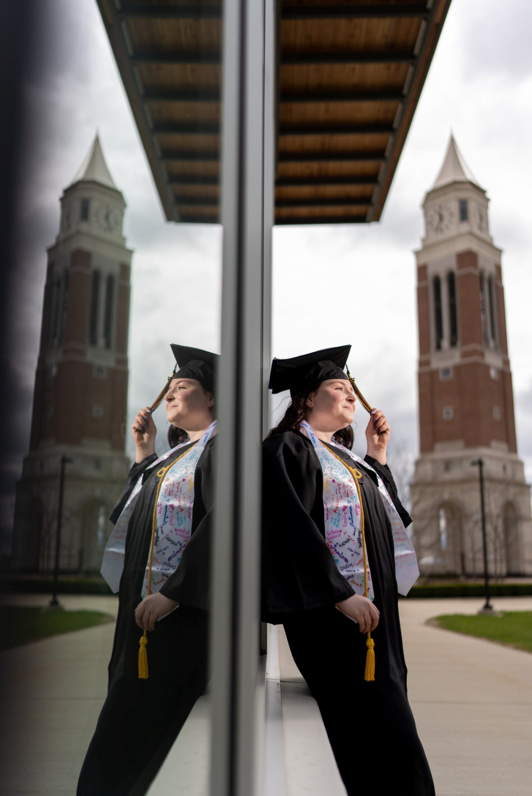 OU college graduation photos in front of Elliot Tower on Oakland University's campus.