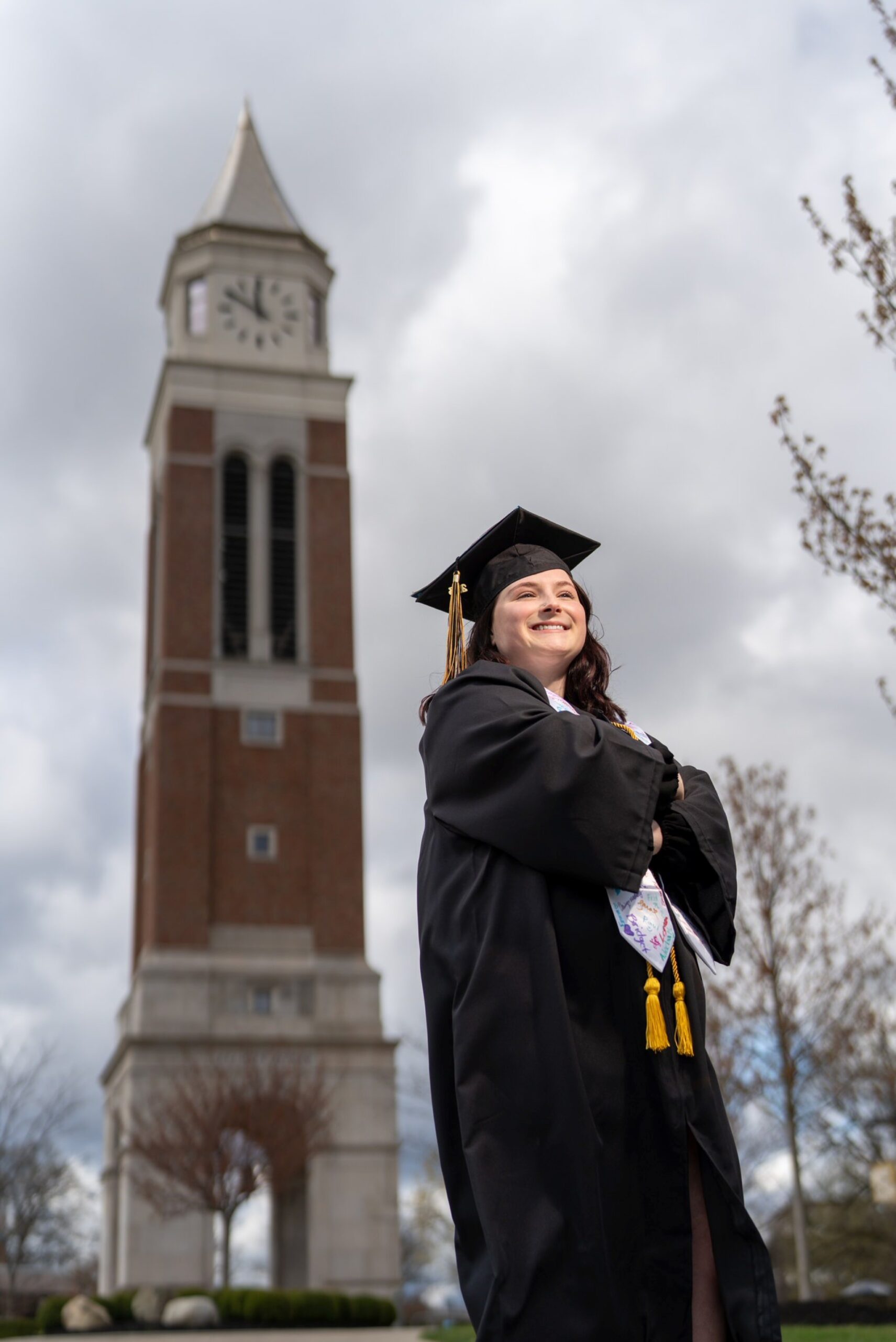 OU college graduation photos in front of Elliot Tower on Oakland University's campus.