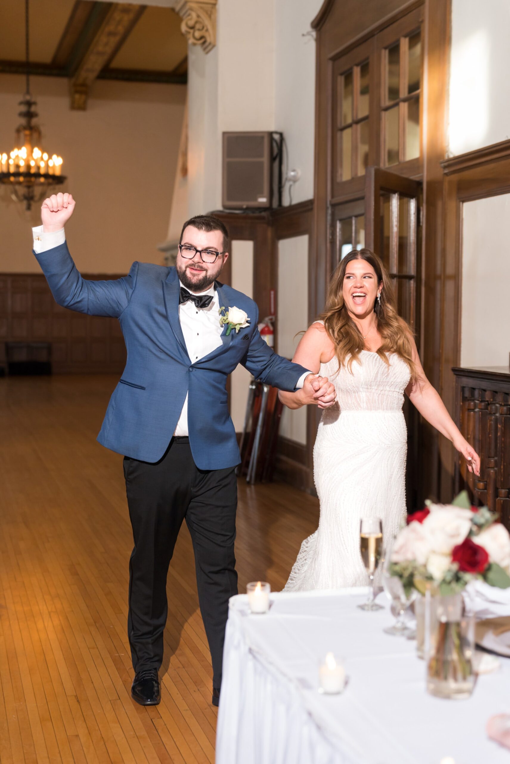 A bride and groom enter the reception of their Detroit Yacht Club wedding. 