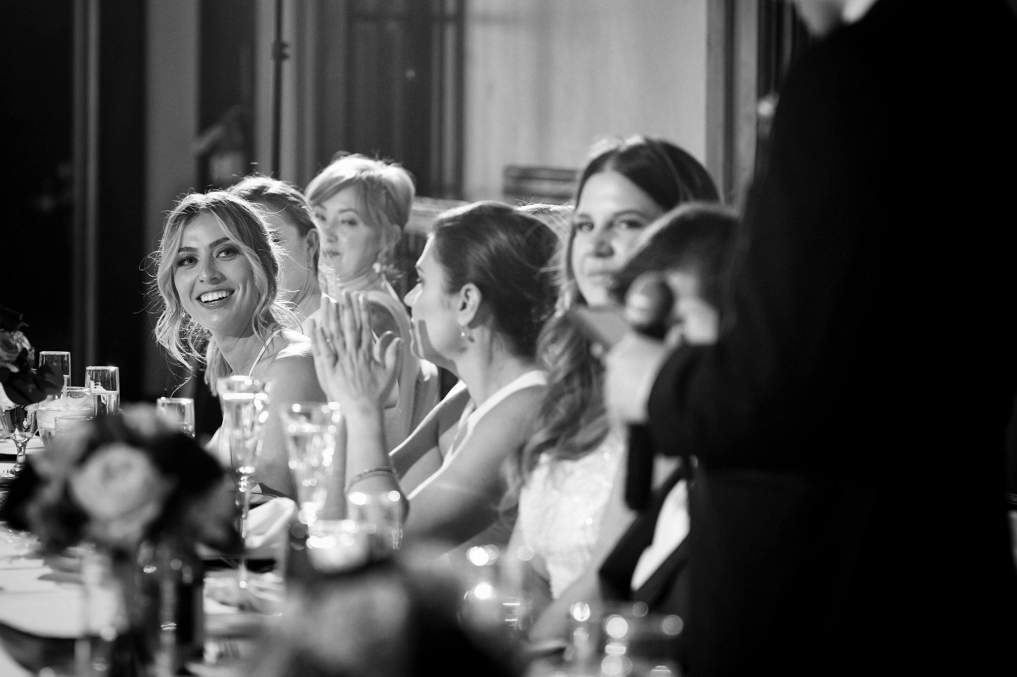 A bridesmaids reacts to a speech during a toast at a Detroit Yacht Club wedding. 