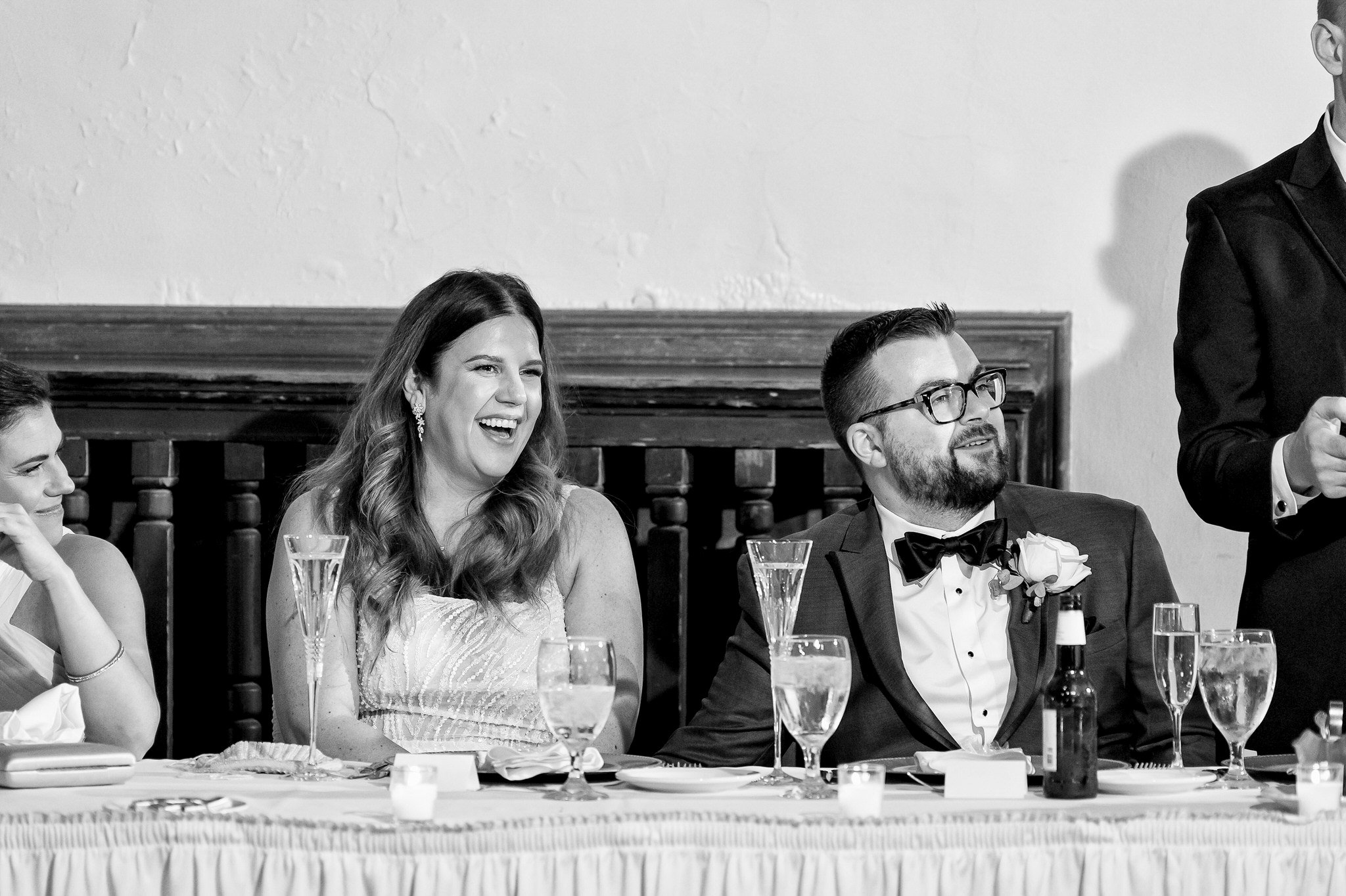 A bride laughs during a speech at a Detroit Yacht Club wedding.
