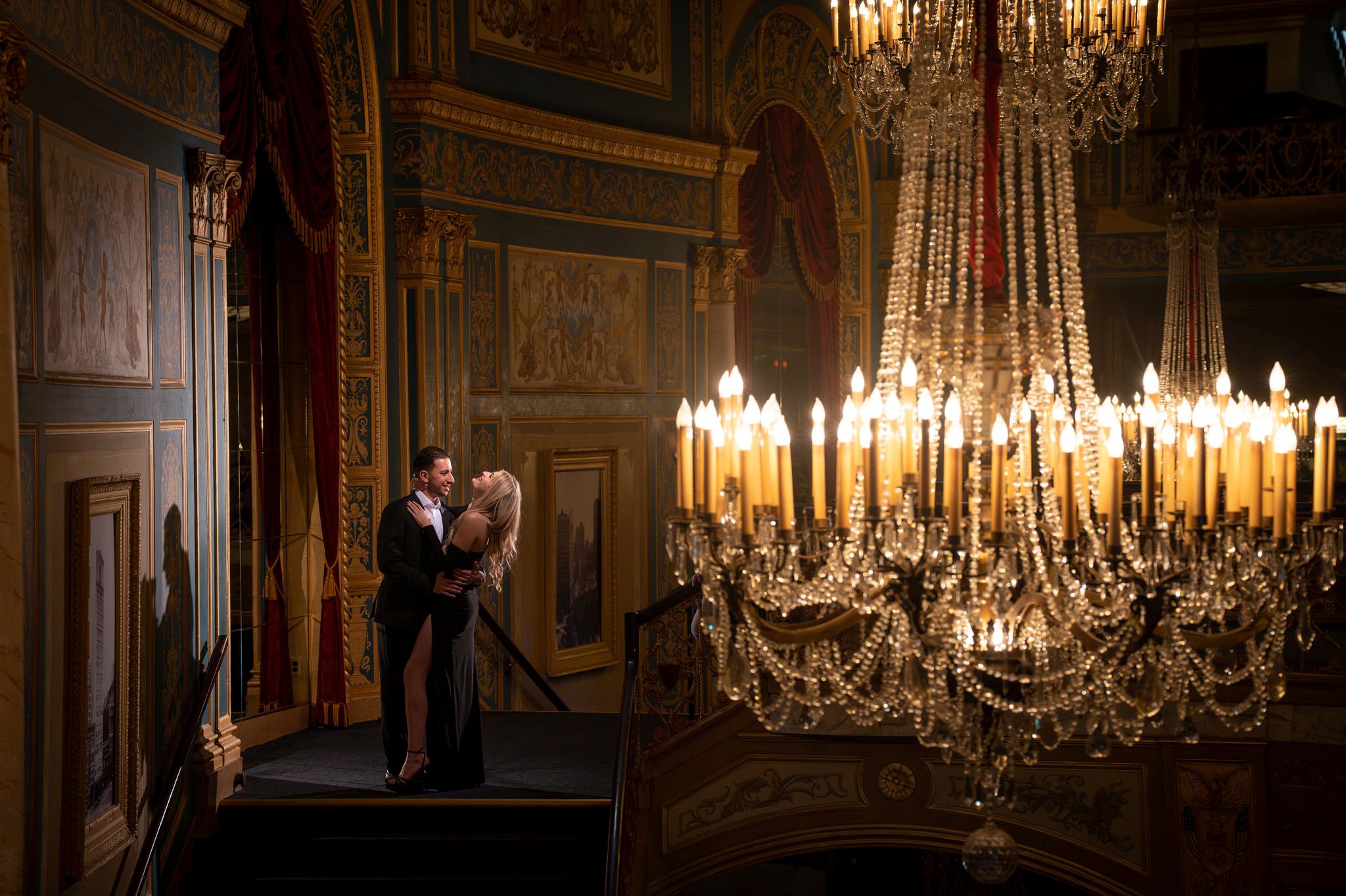 A couple laughs after their proposal at Detroit Opera House. 
