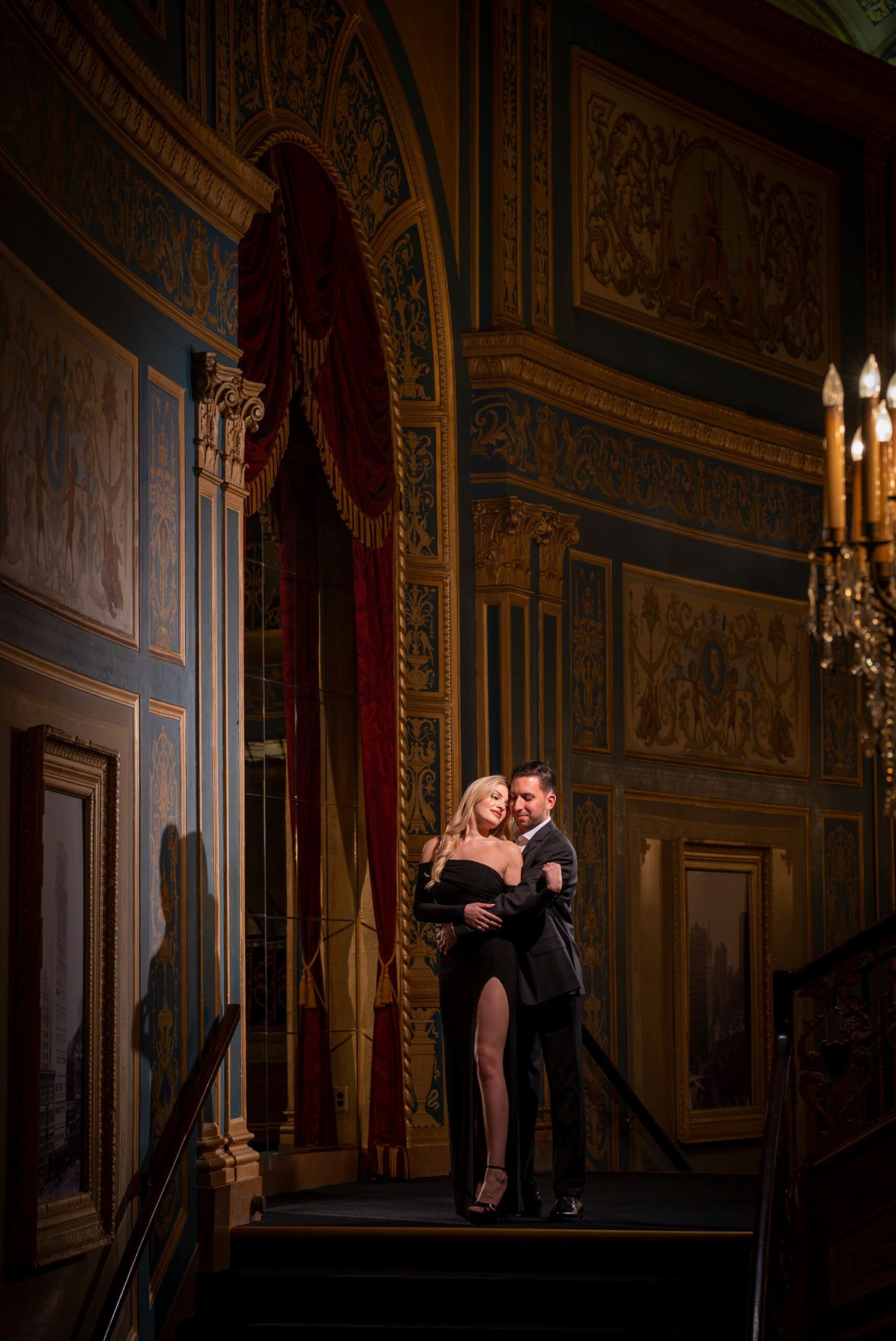 A full body photo of a couple during their proposal at Detroit Opera House. 