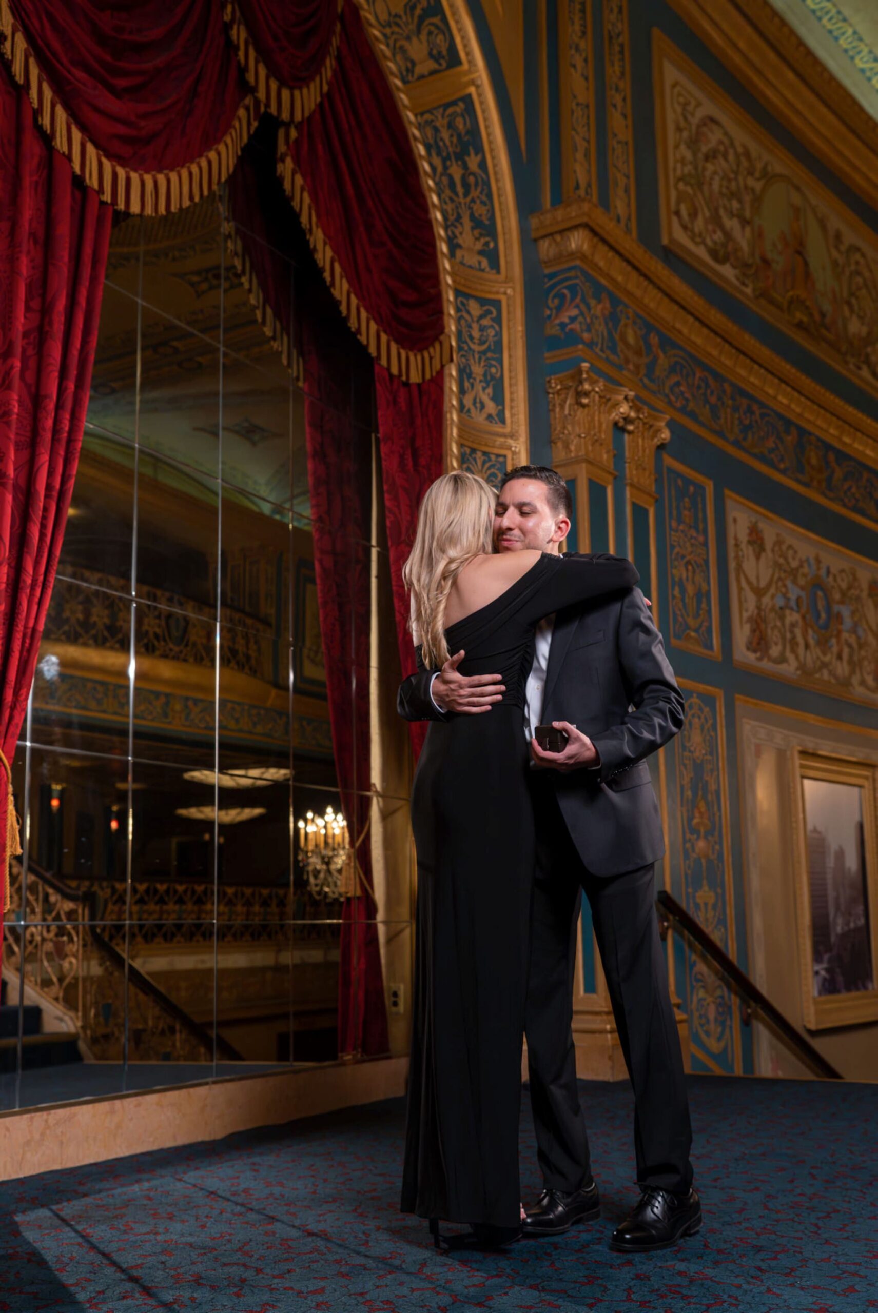 Couple hugs after a marriage proposal at Detroit Opera House.