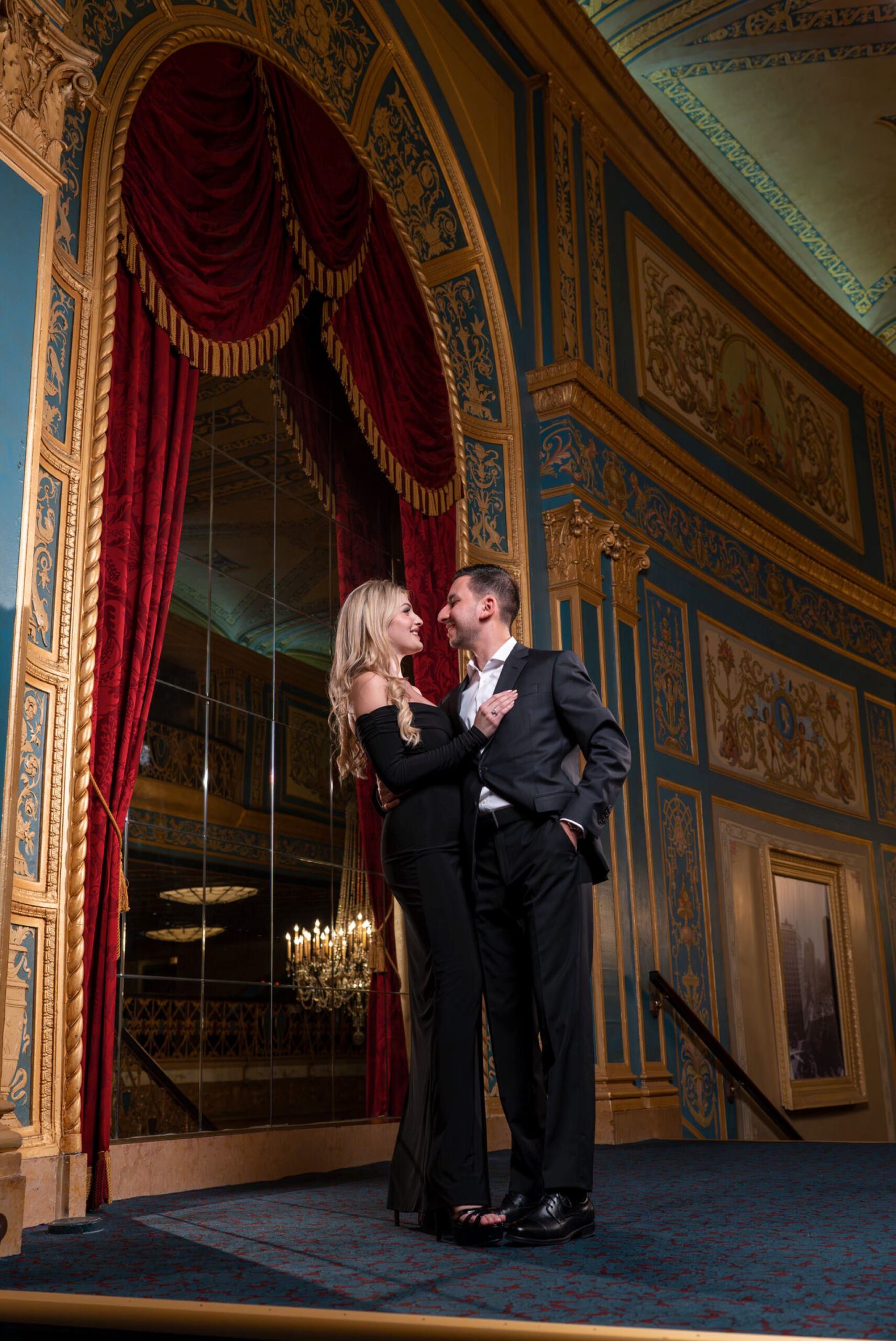 Couple poses after a proposal at Detroit Opera House.