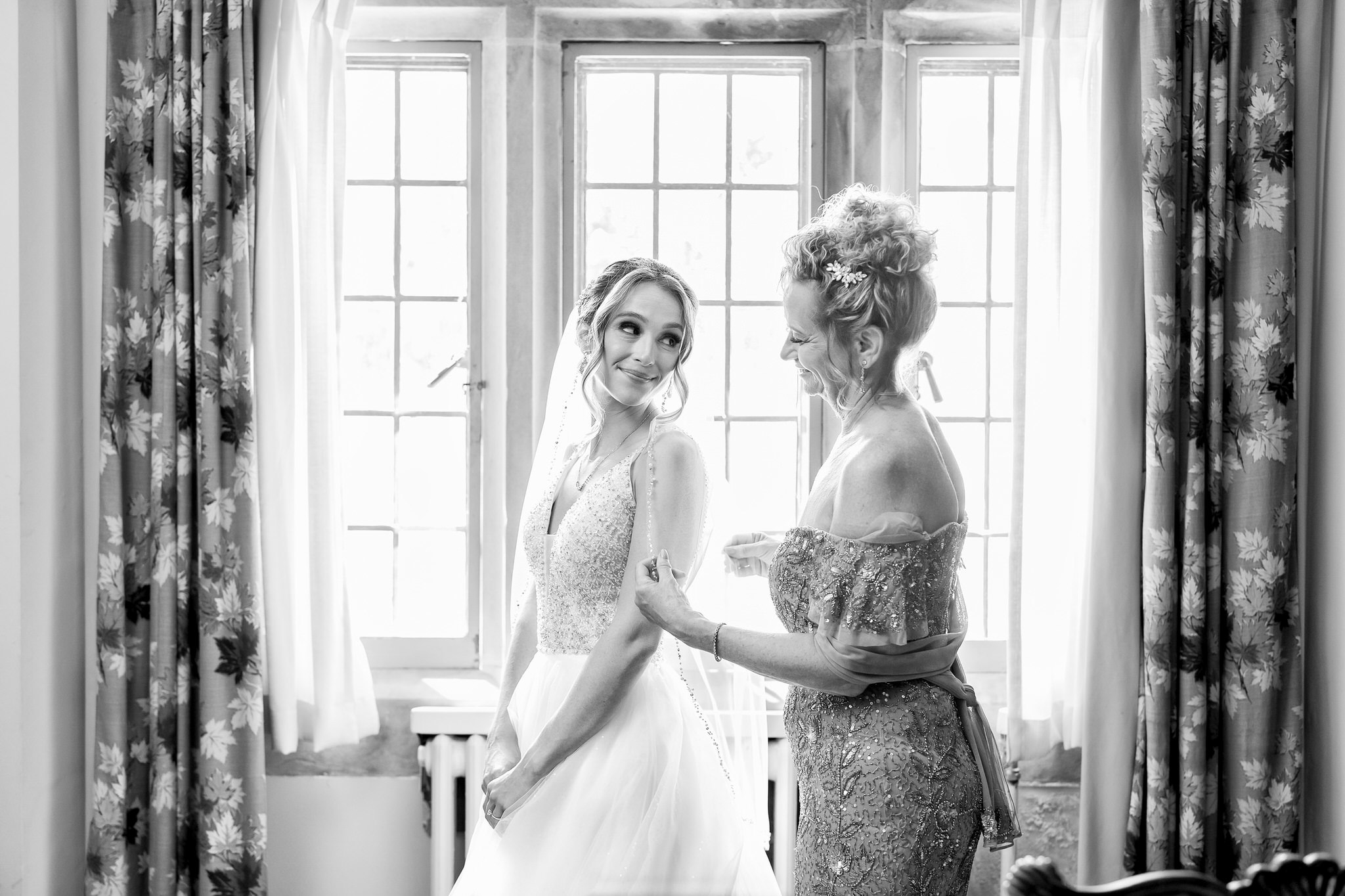 Mom helps her daughter bride get ready for her wedding at Meadowbrook Hall.