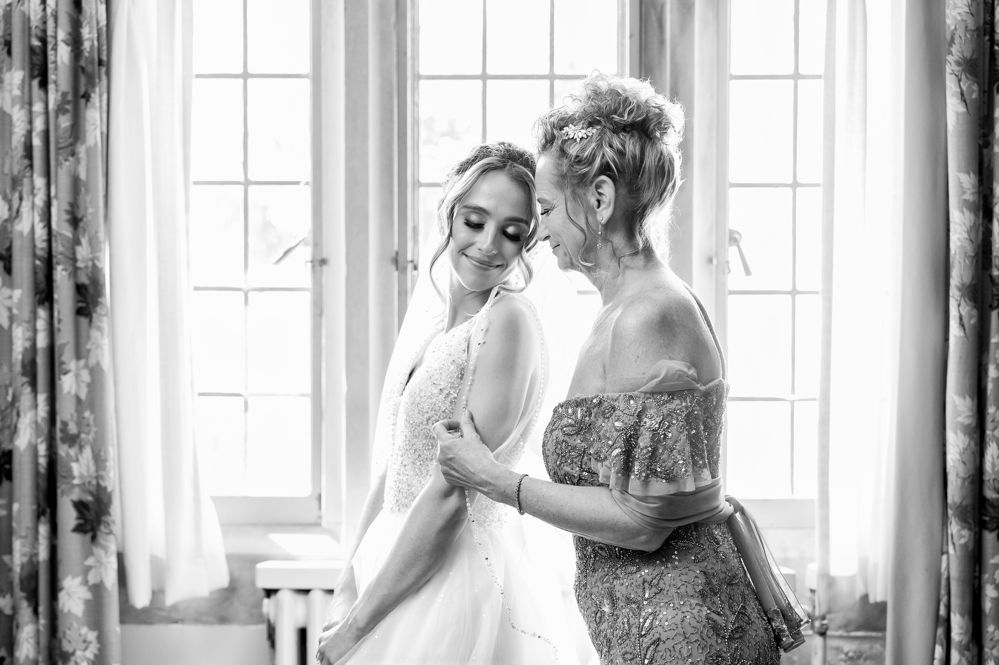 Mom and bride share a quiet moment during her prep before her wedding at Meadowbrook Hall.