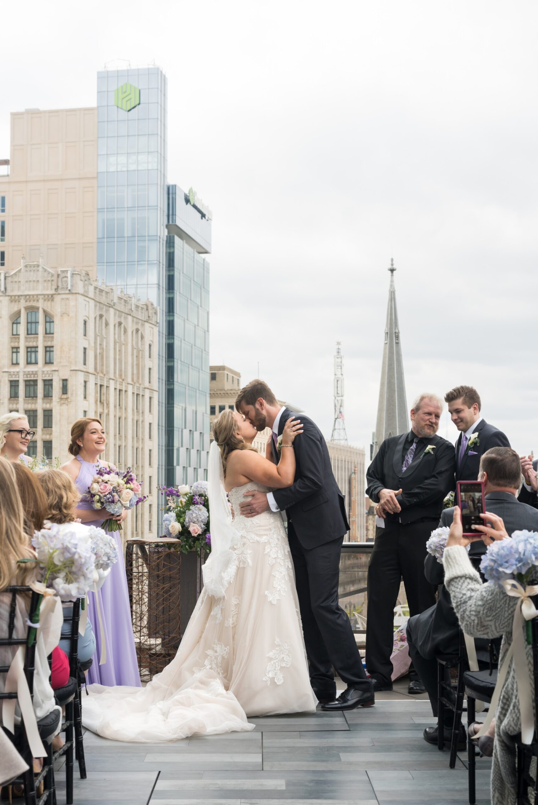 Bride and groom share a first kiss at their Madison Building wedding.