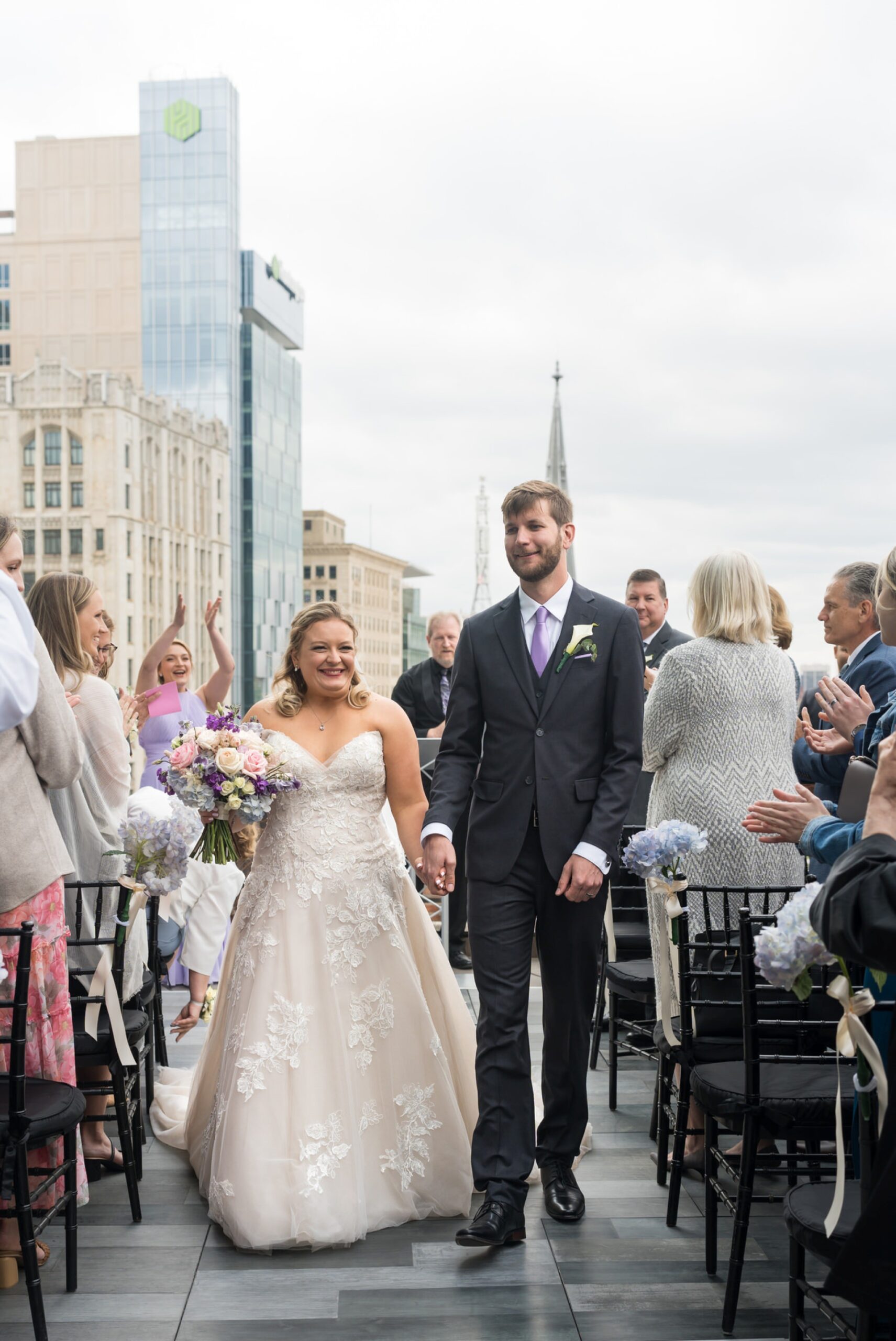 Bride and groom walk down the rooftop aisle at their Madison Building wedding.