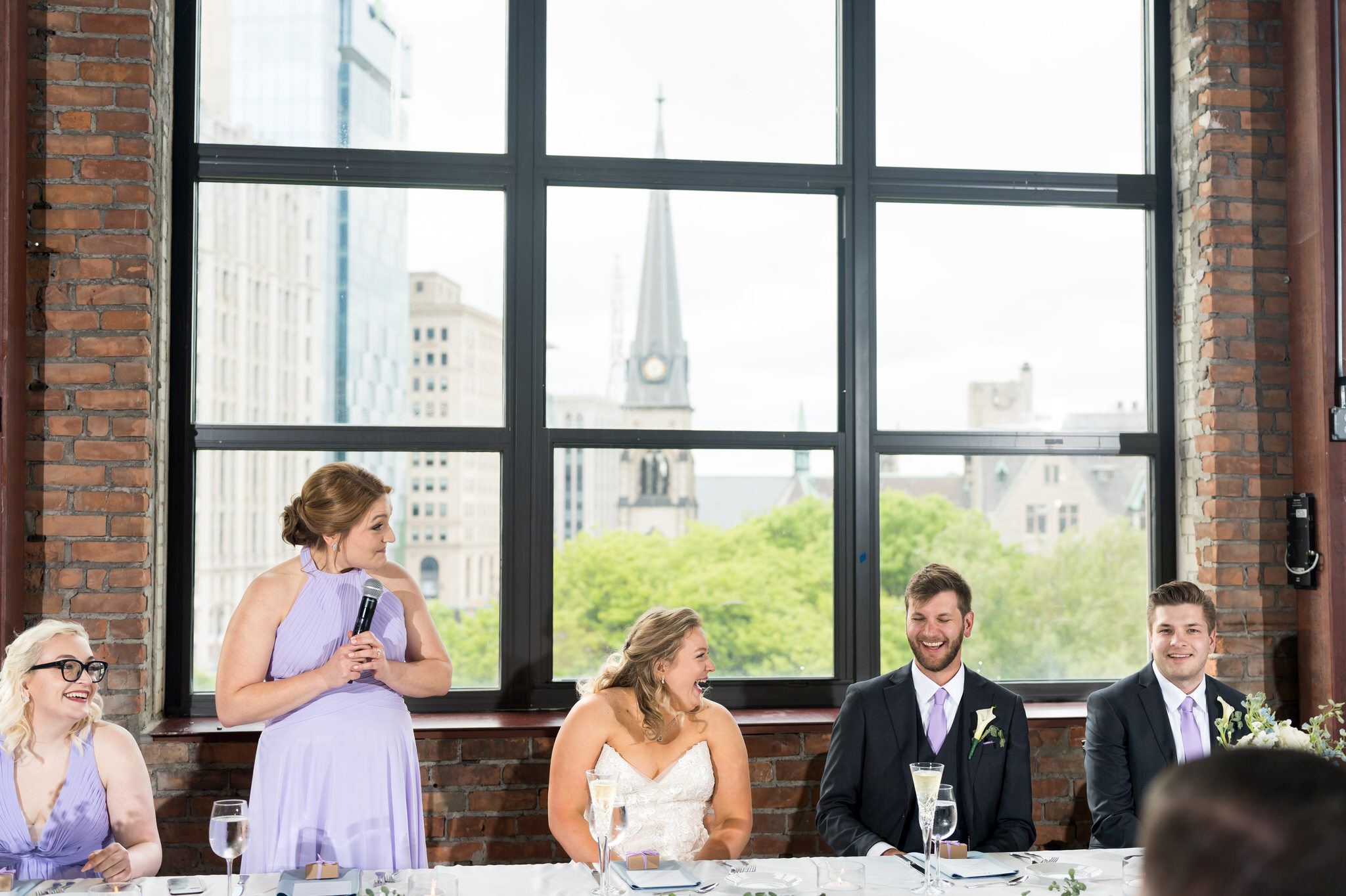 The Maid of Honor delivers a funny speech at a Madison Building wedding reception. 