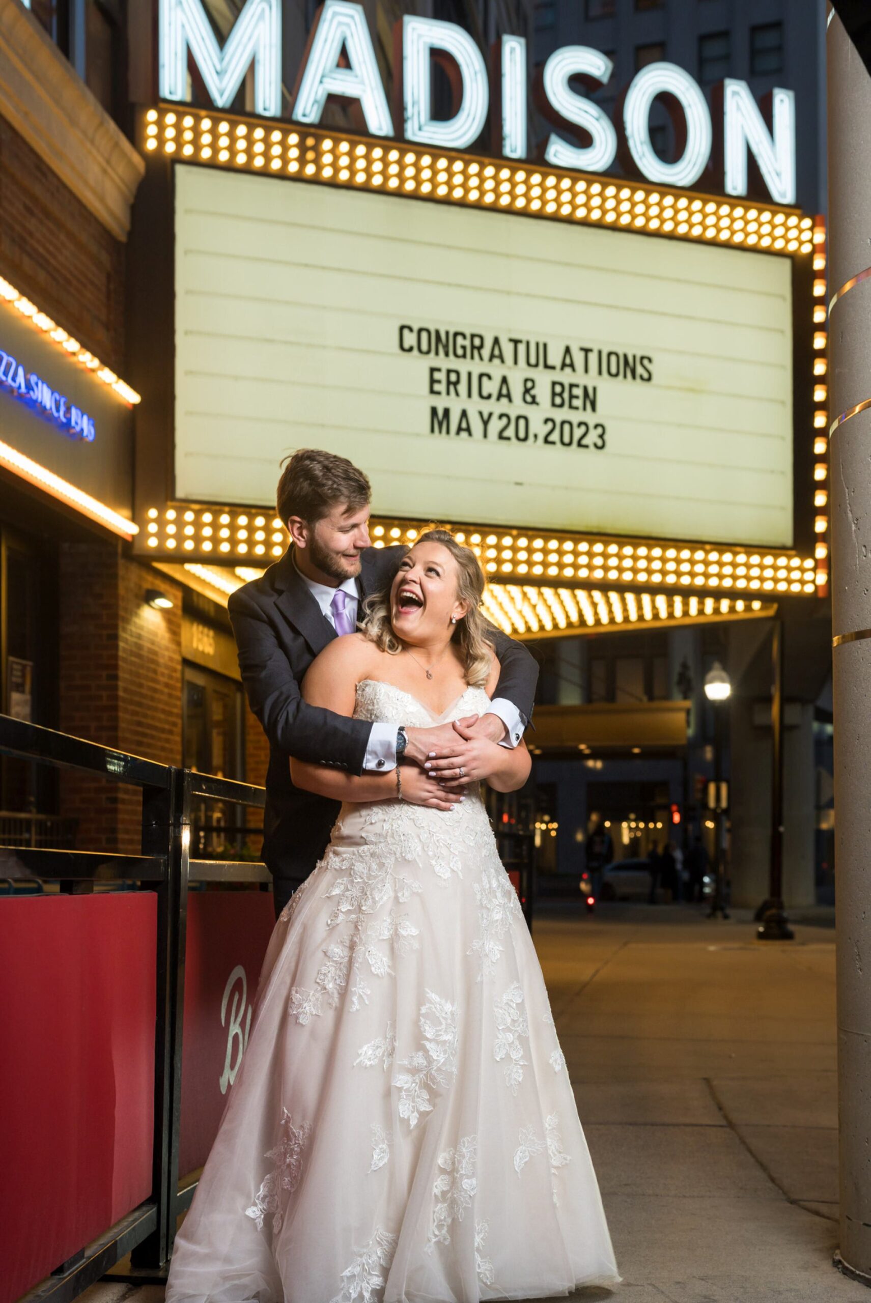 Newlyweds pose in front of marquee at Madison Building wedding.   