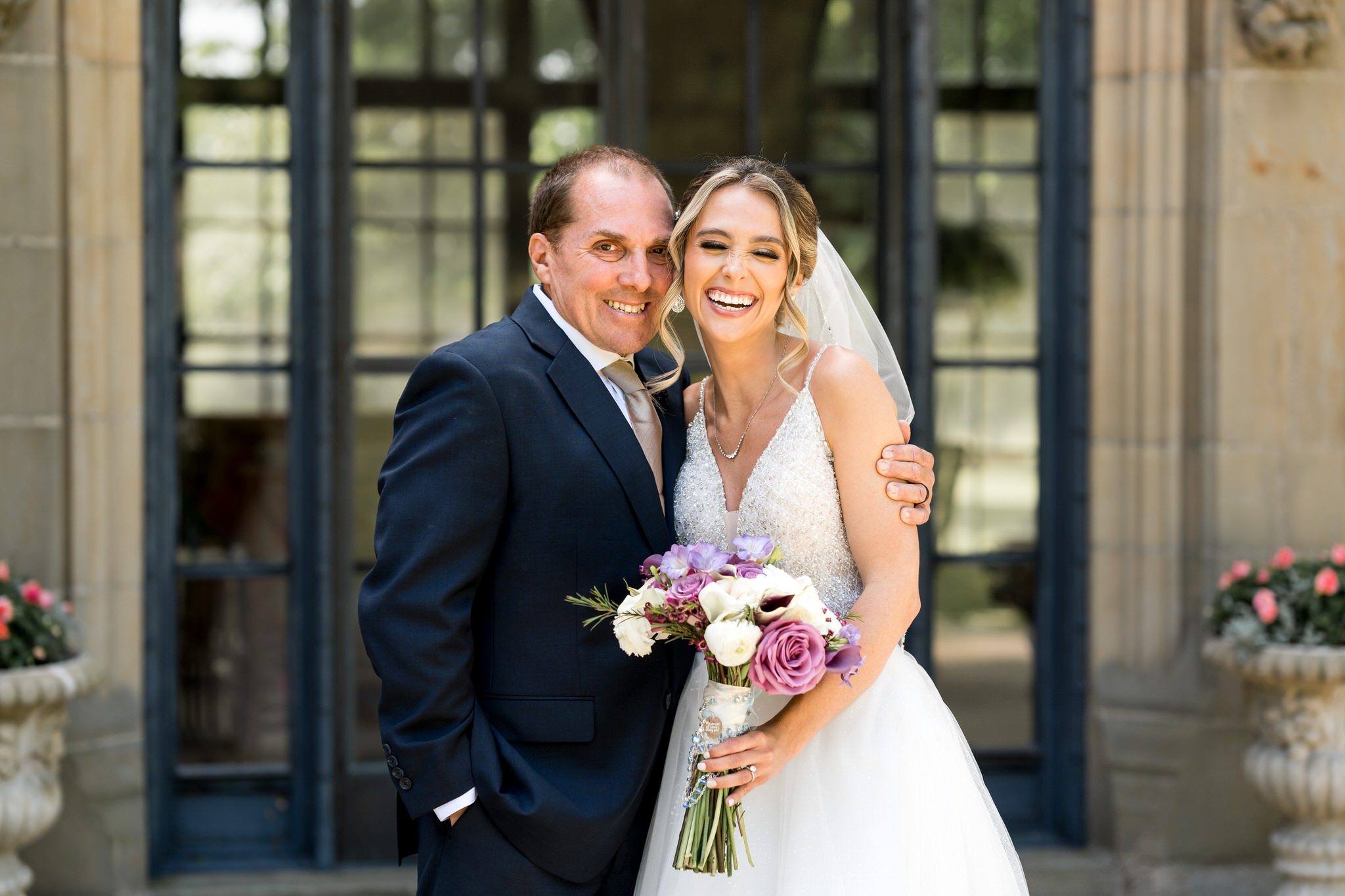 Bride and her dad pose for a photo at her wedding at Meadowbrook Hall.