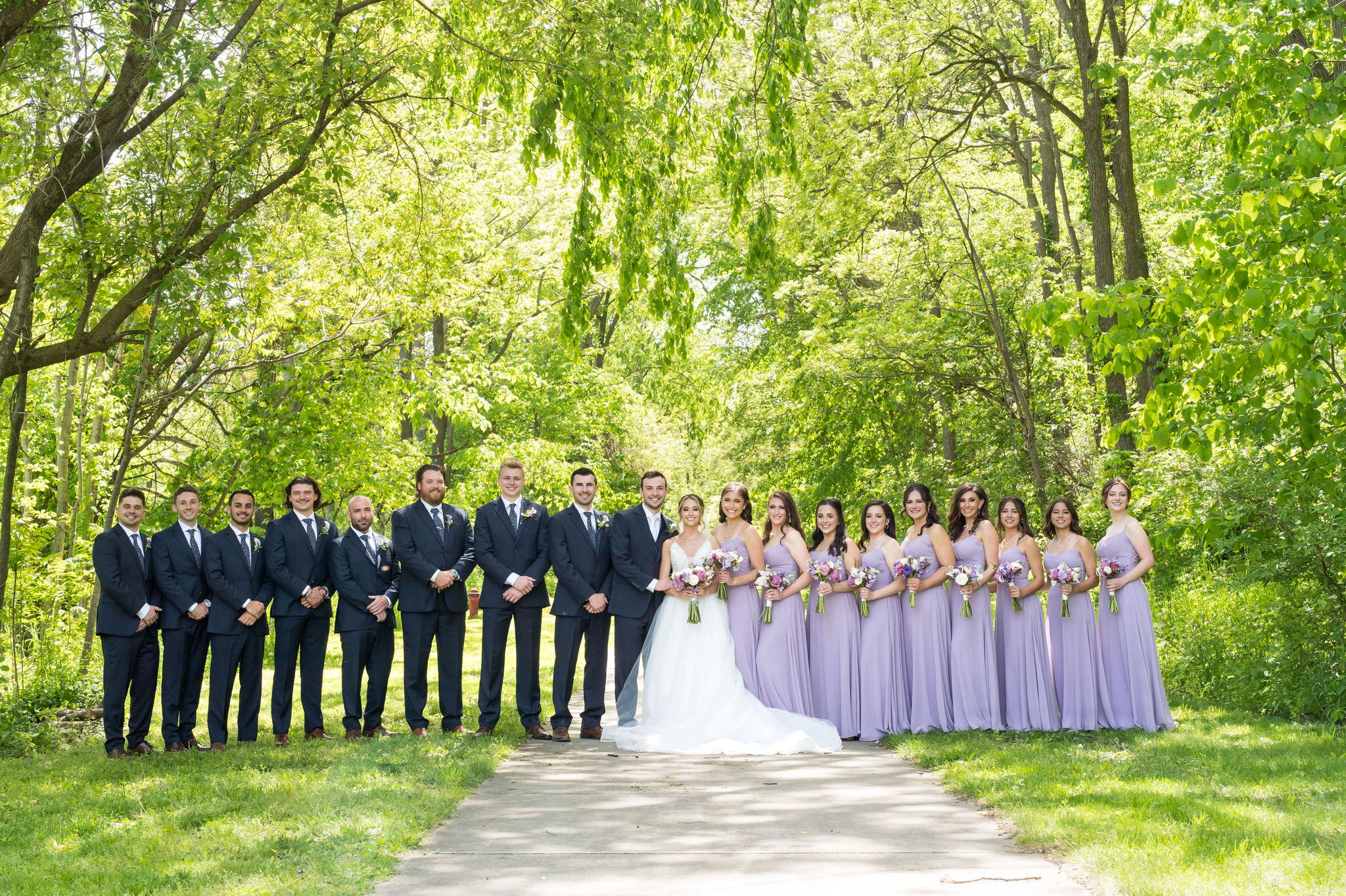 A bridal party poses for a formal photo at Van Hoosen Museum.  