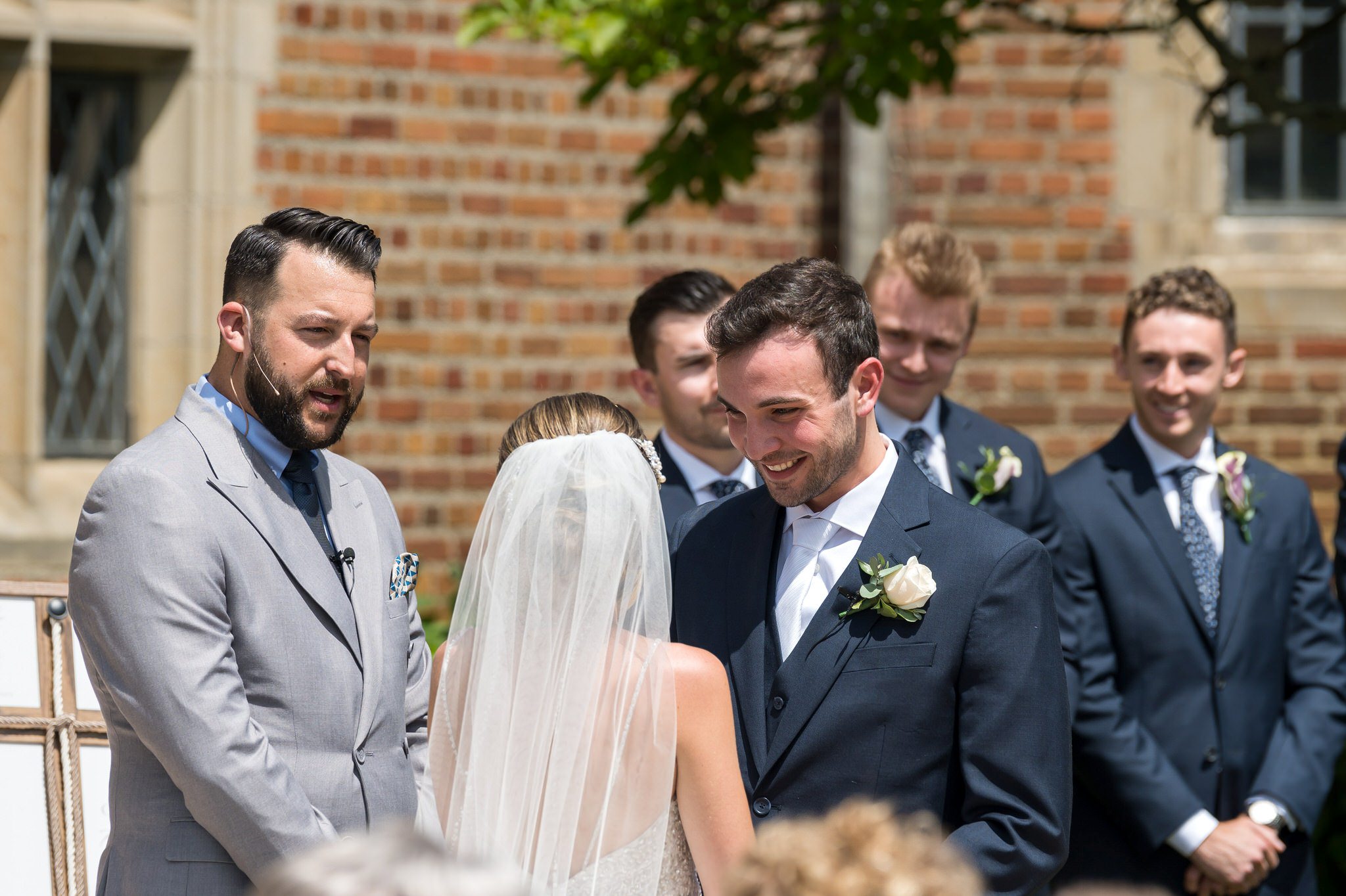 A groom smiles at his bride during their wedding at Meadowbrook Hall. 