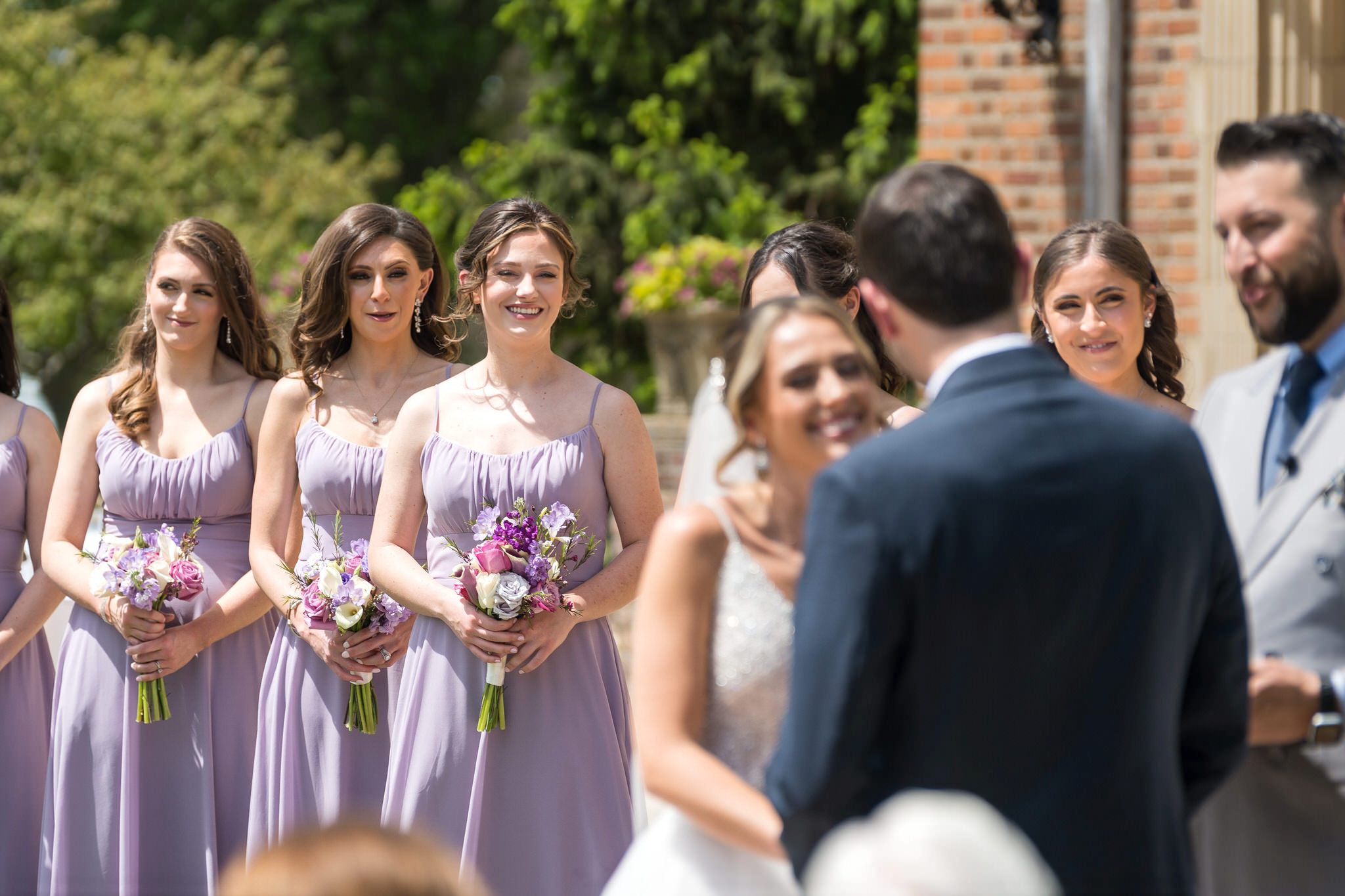 Bridesmaids look onward at a wedding at Meadowbrook Hall. 