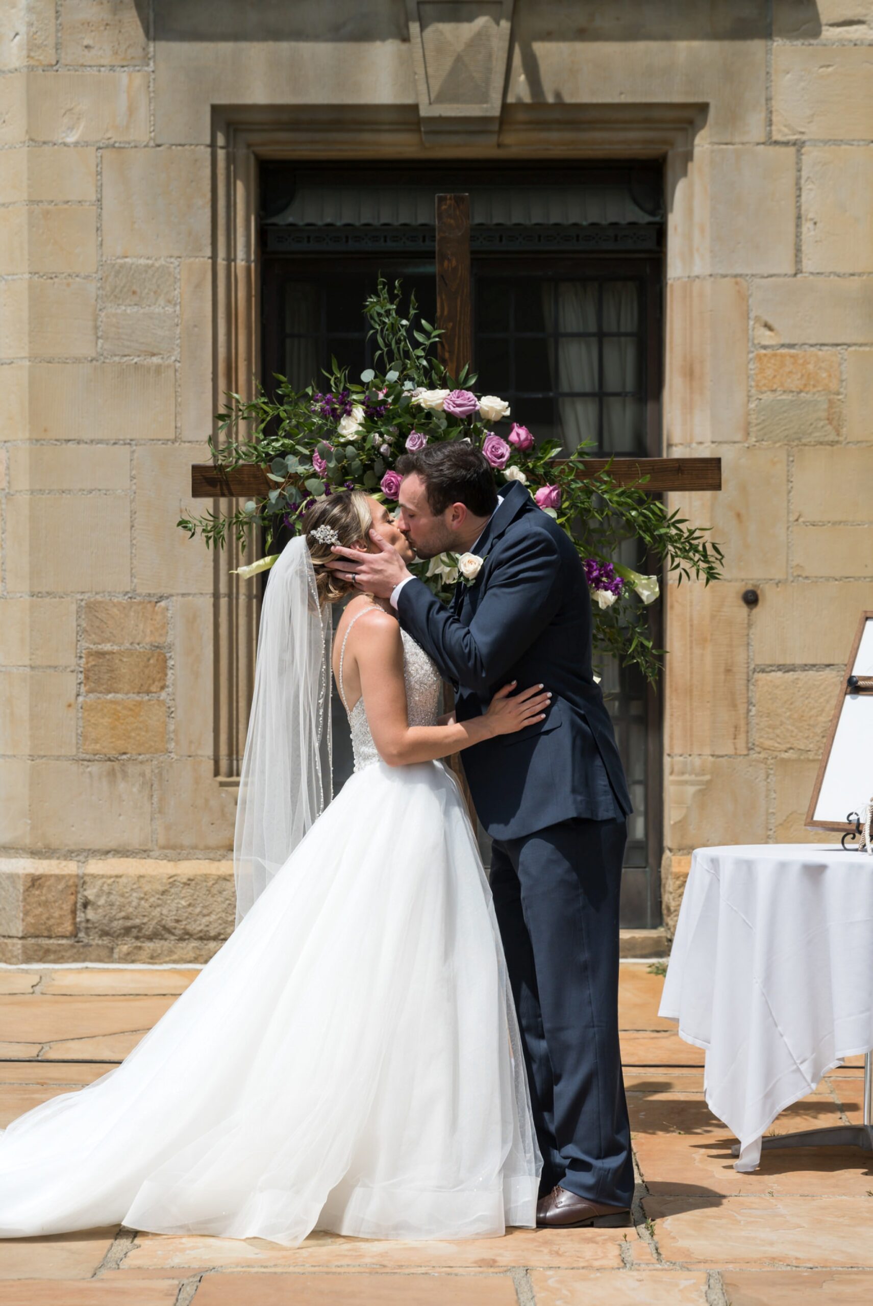 Bride and groom share a first kiss at their wedding at Meadowbrook Hall. 